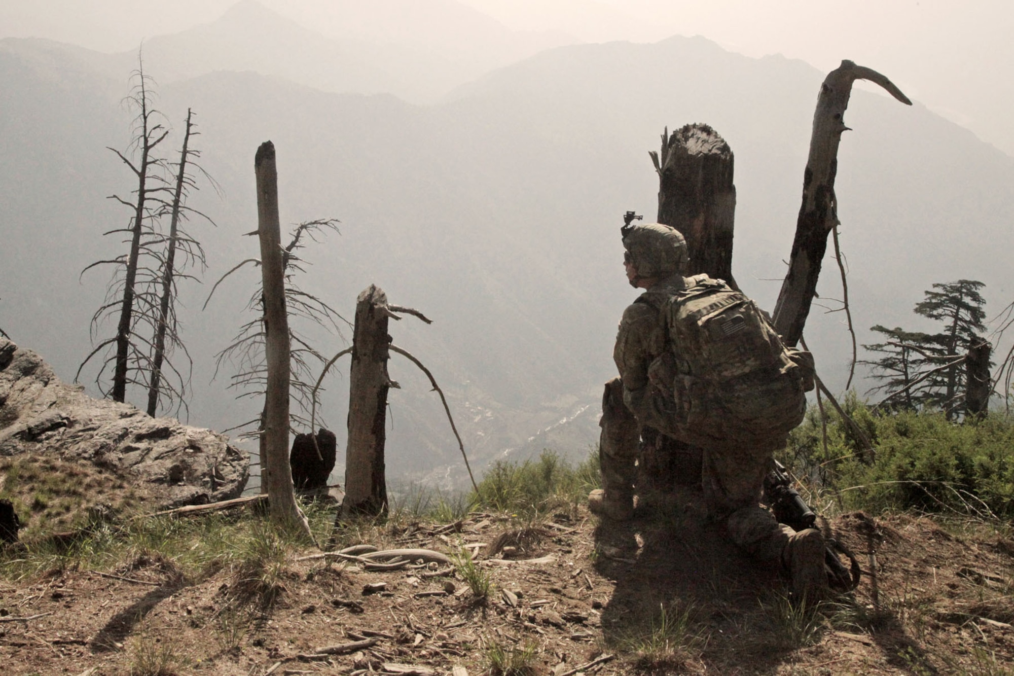 BAGRAM AIRFIELD, Afghanistan -- U.S. Army Pfc. Dallas Wood from D Company, 2nd Battalion, 35th Infantry Regiment, looks over the valley below after dismounting from a landing zone during Operation Hammer Down in the Watahpur District of Kunar province, Afghanistan, June 24. The operation was a coalition effort to disrupt insurgents operating and training throughout the Pech Valley. (U.S. Army photo by Spc. Tia Sokimson)