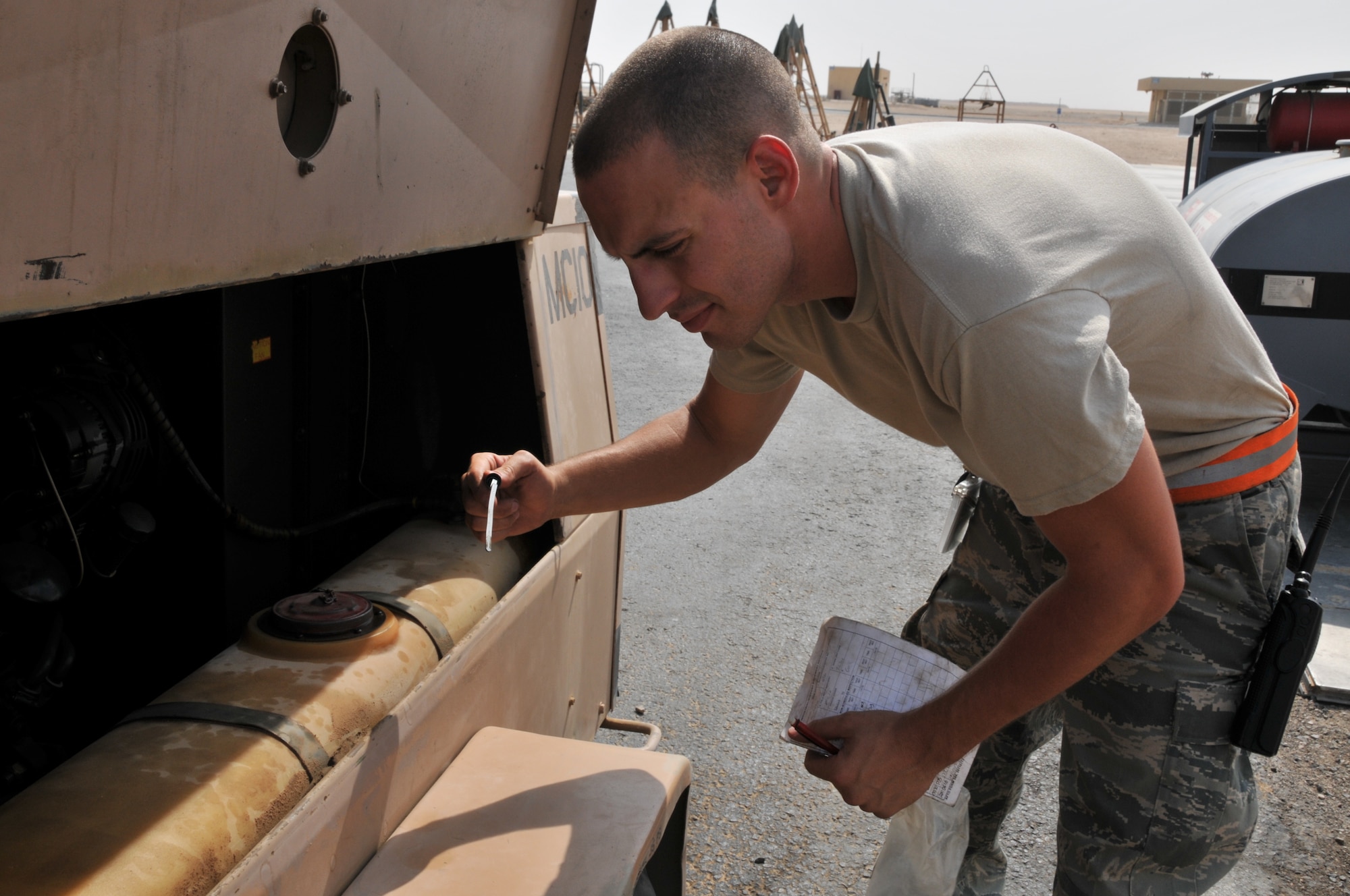 Airman 1st Class John Roese, 379th Aerospace Ground Equipment flight, deployed from Seymour-Johnson Air Force Base, N.C., checks the oil level in a piece of equipment used to duplicate aircraft systems while it is on the ground, July 4, at an undisclosed location in Southwest Asia.(U.S. Air Force photo/ Senior Airman Eric Summers Jr.)