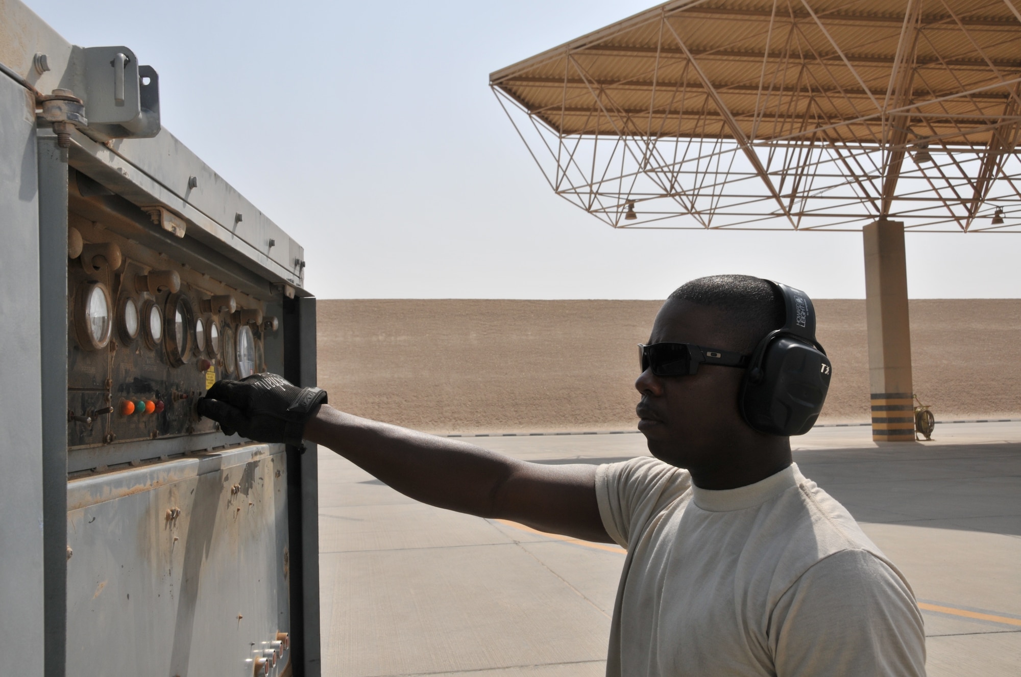 Airman 1st Class  Randy Clayton, 379th Aerospace Ground Equipment flight. driver, deployed from Ramstein Air Force Base, Germany, tests different components of a MA-3D airconditioner unit  prior to using it on an aircraft, July 4, at an undisclosed location in Southwest Asia.  The AGE shop supplies and maintains more than 197 pieces of equipment that are used to help maintain aircraft and get them back into the fight. (U.S. Air Force photo/ Senior Airman Eric Summers Jr.)