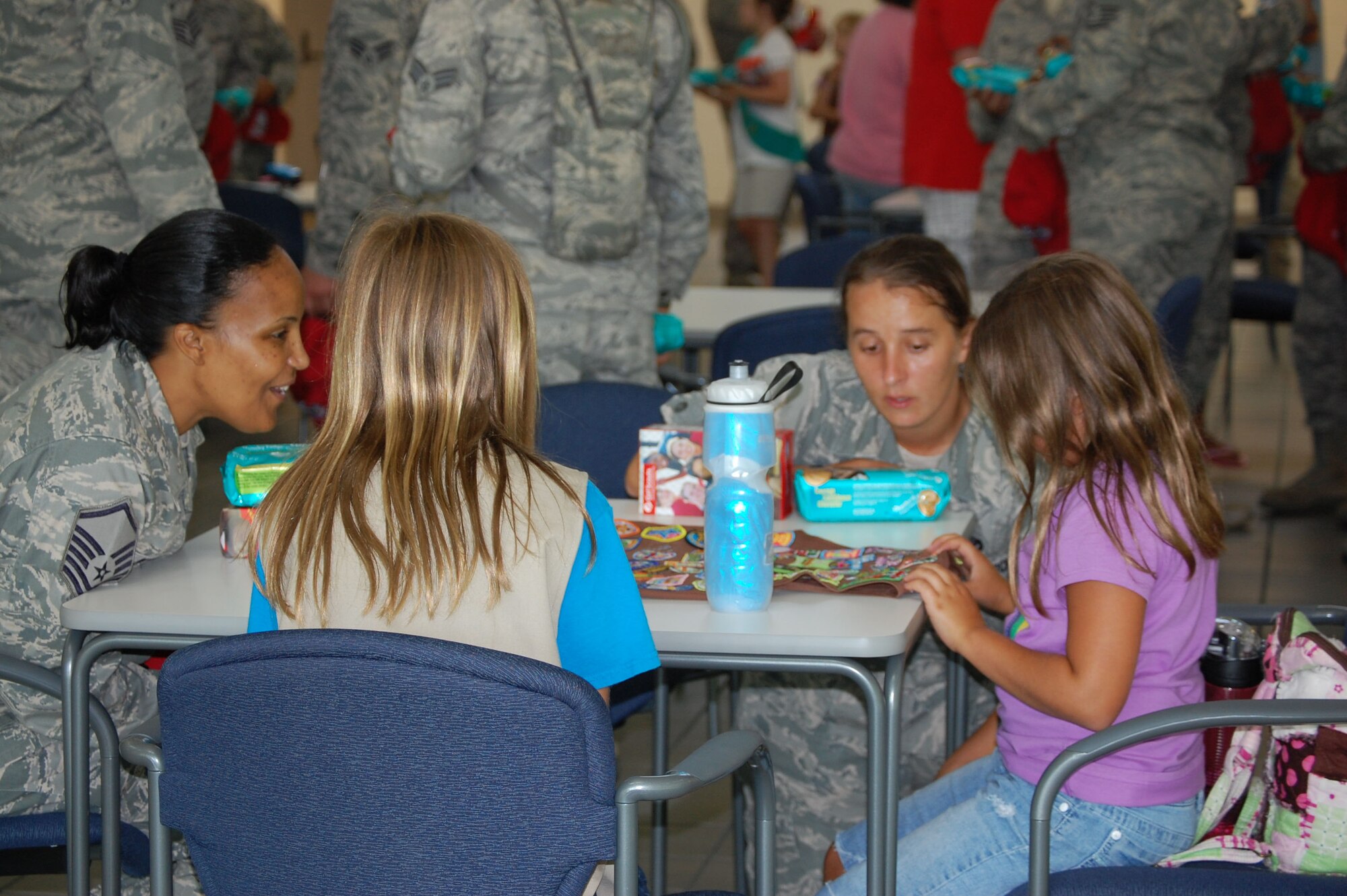 Master Sgt Tracy Davis, a contracting specialist and Airman First Class Julie O'Guinn, a structures ppprentice met with Girl Scouts from the local area on Sat. July 9. Sixty scouts visited Seymour Johnson to pass out cookies to Airmen preparing to deploy. Davis and O'Quinn are reservists with the 567th RED HORSE Squadron. (USAF photo by Donna Lea, 916ARW/PA)