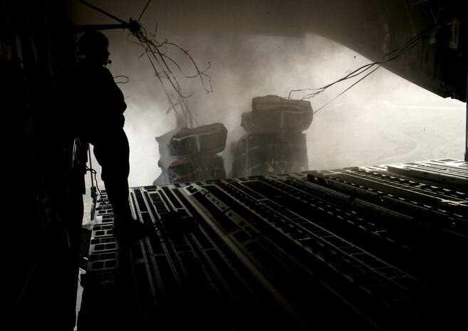 Staff Sgt. Stephen Adams, 816th Expeditionary Airlift Squadron loadmaster, observes 36,500 pounds of JP8 fuel fly out the back of a C-17 Globemaster III over Afghanistan July 8, 2011. The C-17 dropped more than 121,000 pounds of food and fuel during a 15-hour mission.  Supplies were dropped to U.S. and coalition troops. (U.S. Air Force photo by Staff Sgt. David Salanitri)