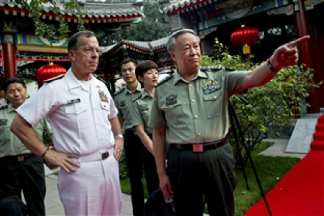 U.S. Navy Adm. Mike Mullen, chairman of the Joint Chiefs of Staff, receives a tour by Chinese Gen. Chen Bingde, chief of the People's Liberation Army's General Staff, in Beijing, July 10, 2011. Mullen is on a three-day trip to the country to meet with counterparts and Chinese leaders.