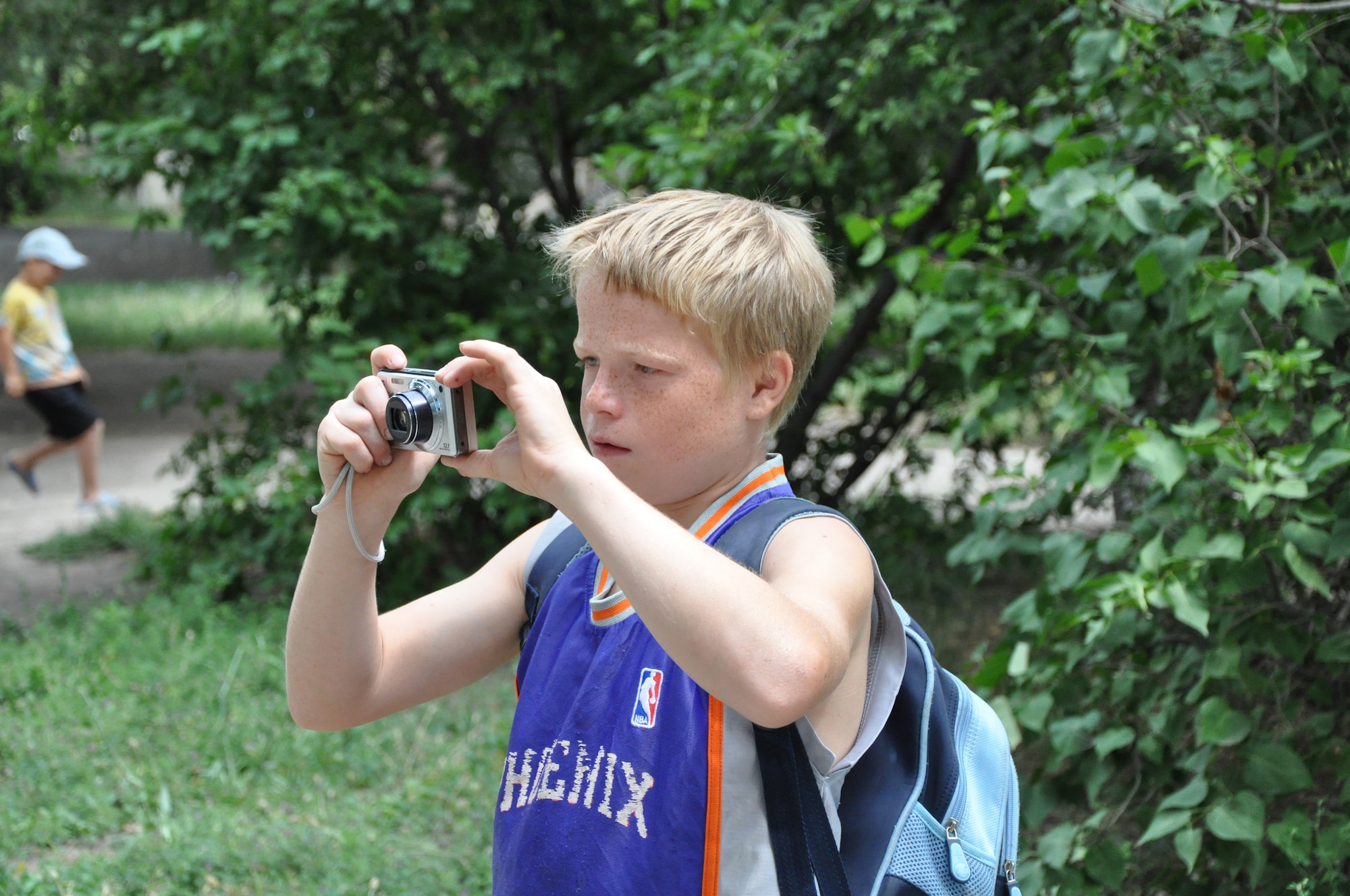 Sergei enjoys taking pictures with one of his visitor's cameras. The 376th Security Forces Squadron "Cops for Kids" chose the Red River Orphanage as one they would "adopt." The defenders have formed close relationships with the children there, including Sergei, who is called "Big Boss" by the defenders for his leadership skills with the other children at the orphanage. (U.S. Air Force photo/Master Sgt. Cindy Dorfner)