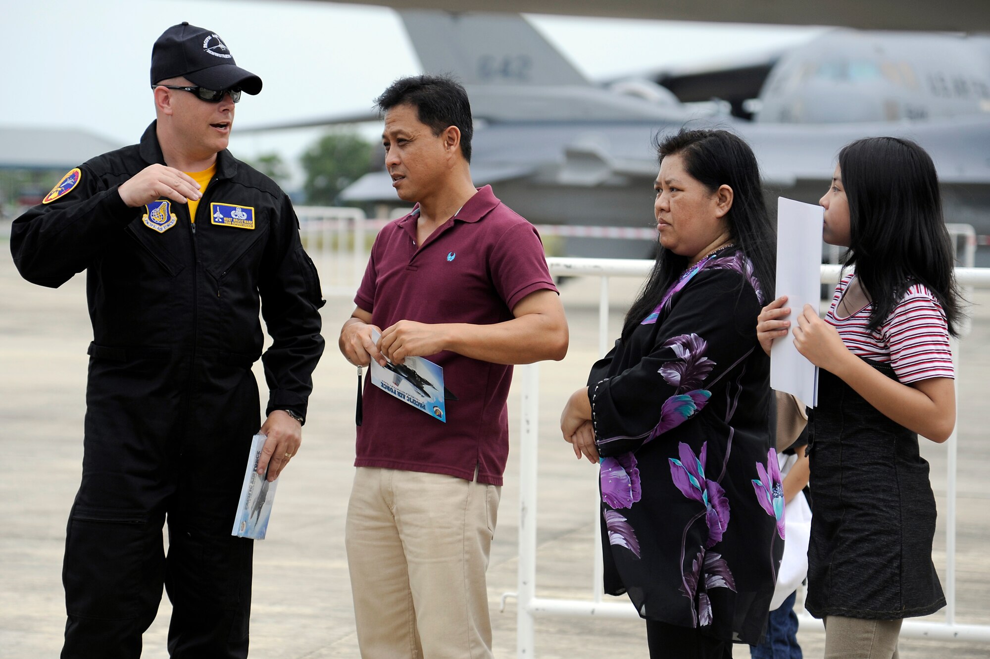 Brunei Darussalam -- Master Sgt. Bruce Wark, Pacific Air Forces Demonstration Team superintendent, talks with a local family at the F-16 Fighting Falcon static display during the 3rd Biennial Brunei Darrussalam International Defense Exhibition July 6. BRIDEX provided a platform for leading manufacturers, suppliers and decision makers to deliberate on military solutions and showcase innovative technologies. (U.S. Air Force photo/Staff Sgt. Marie Brown/Released)