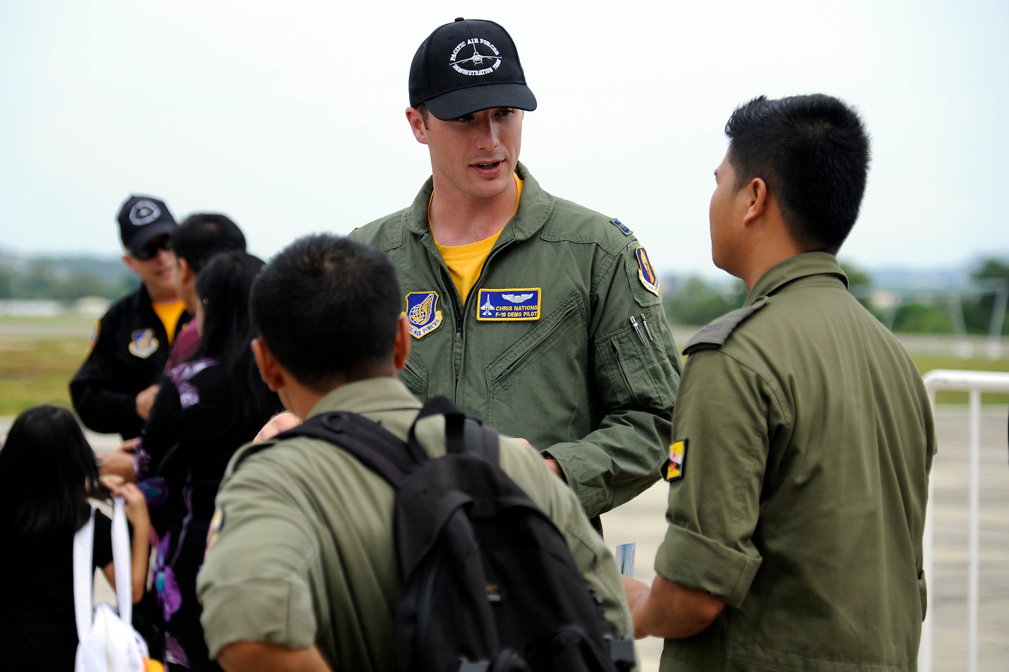 Brunei Darussalam -- Capt. Chris Nations, center, Pacific Air Forces Demonstration Team pilot, talks with foreign military members at the F-16 Fighting Falcon static display during the 3rd Biennial Brunei Darrussalam International Defense Exhibition July 6. BRIDEX 2011 is themed "Mapping Future Security and Technological Challenges," and was organized by the Brunei Ministry of Defense together with the Sultan Haji Hassanal Bolkiah Institute of Defense and Strategic Studies. (U.S. Air Force photo/Staff Sgt. Marie Brown/Released)