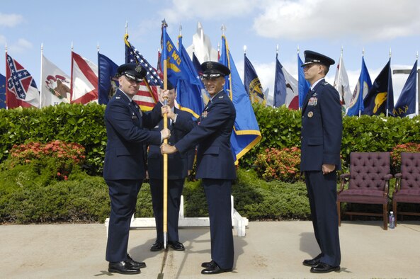 Col. Sam Barrett, 15th Wing commander, takes the guidon from Col. Jeffrey Morgan, outgoing 15th Operations Group commander, during a change of command ceremony here, July 8. Colonel Morgan is making a permanent change of station to the Pentagon and relinquished command to Col. David Baldessari, 15 OG commander. Colonel Baldessari, a U.S. Air Force Academy graduate, entered the Air Force in 1989. He is a command pilot with more than 3,700 flight hours. He previously served as the United States Transportation Command Liaison Officer to North American Aero Space Defense. (U.S. Air Force photo/Dave Underwood) 
