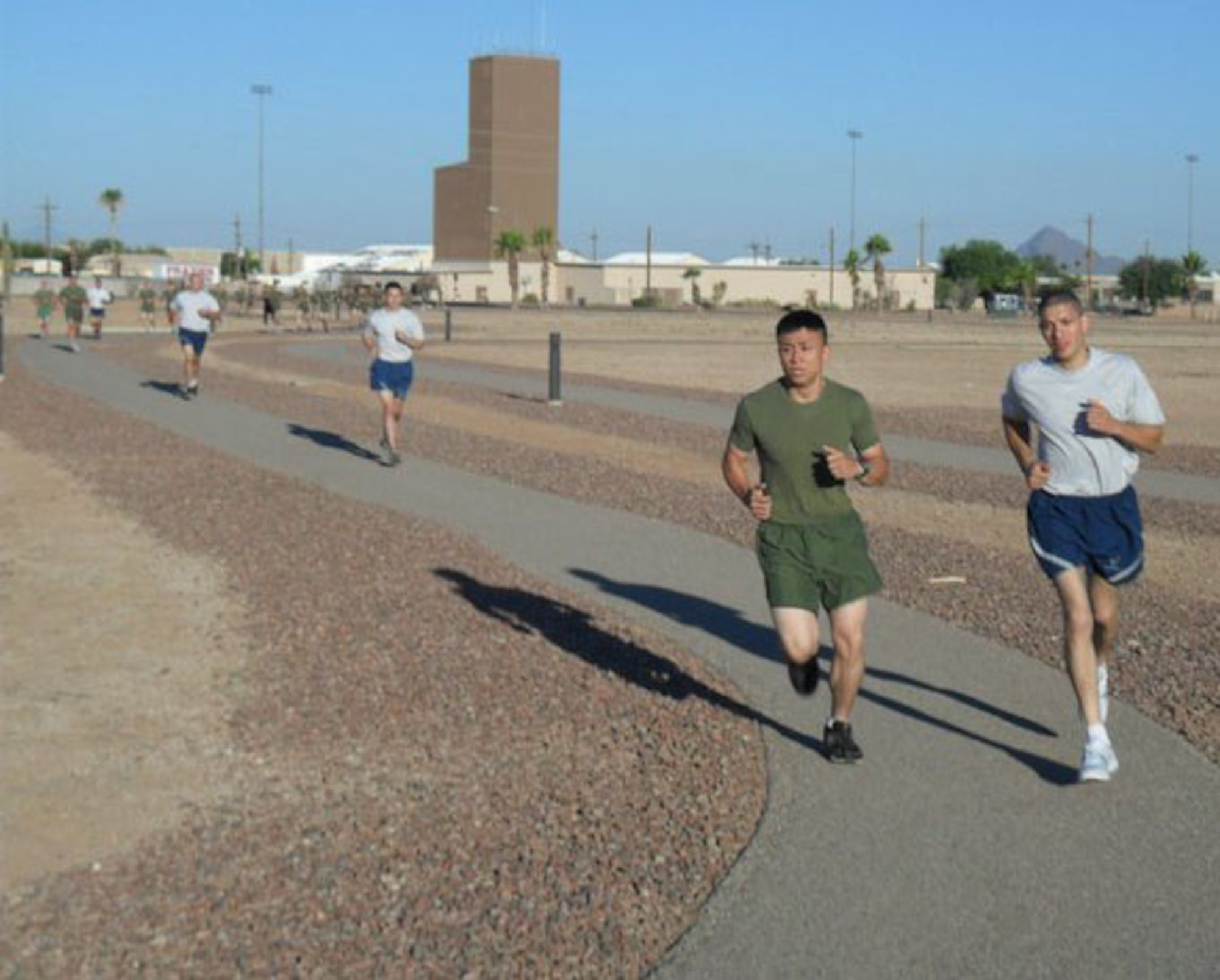 U.S. Air Force Senior Airman Alain Alfaro and U.S. Marine Corps Corporal Huy Tran run together at a physical training session during the Corporals Course held at Davis-Monthan Air Force Base, Ariz. June 10-14. Six Airmen attended the Marine Corps’ Corporals Course, a program which trains corporals for their transition to the rank of noncommissioned officer. (Courtesy photo)