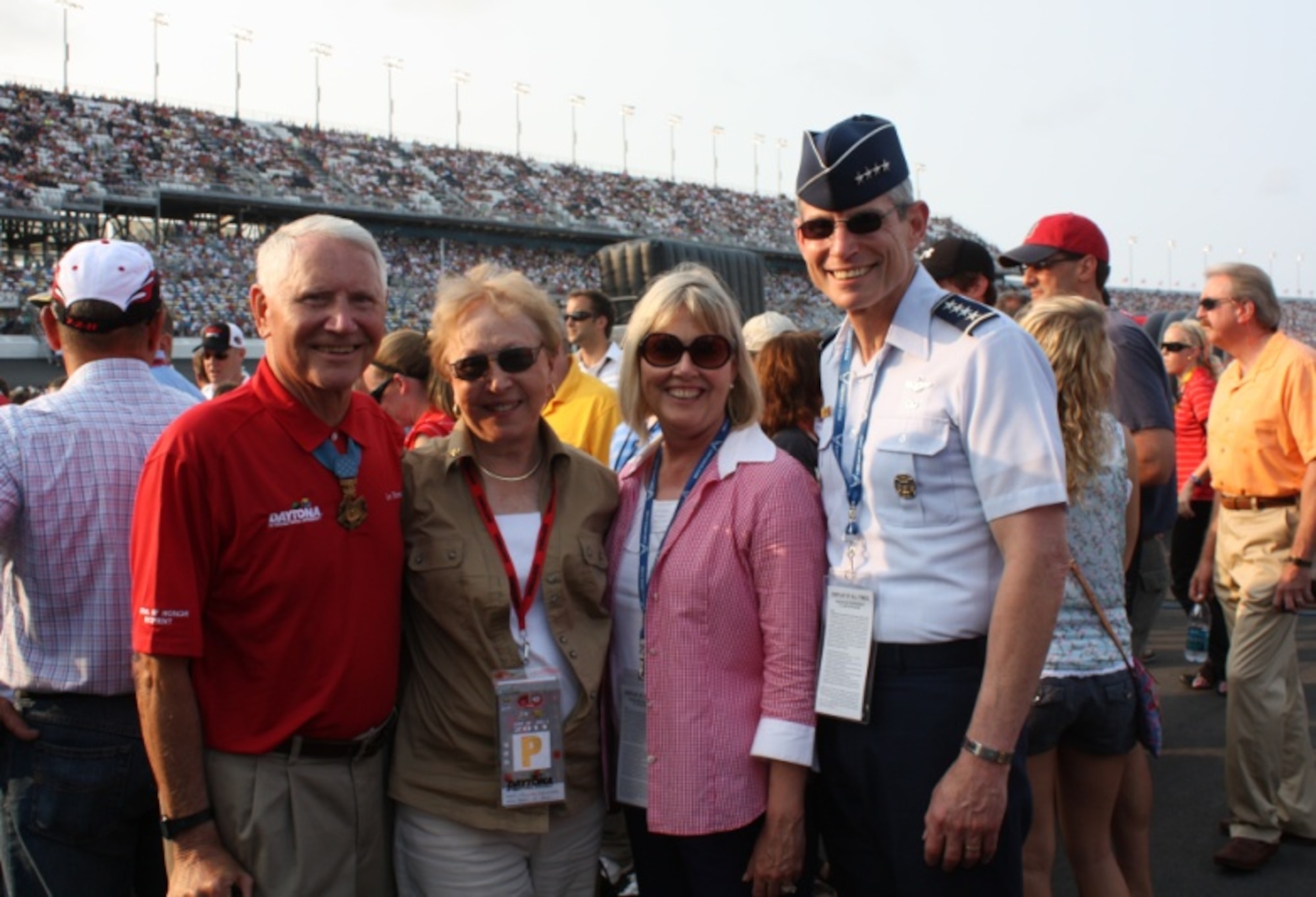 Air Force Chief of Staff Gen. Norton Schwartz and his wife Suzie (second from right) pose for a photo with retired Col. Leo Thorsness and his wife Gaylee.  Colonel Thorsness was among many Medal of Honor recipients recognized during the opening ceremonies July 2, 2011, at the Coke Zero 400 in Daytona Beach, Fla. (U.S. Air Force photo/Capt. Maggie M. Silva)