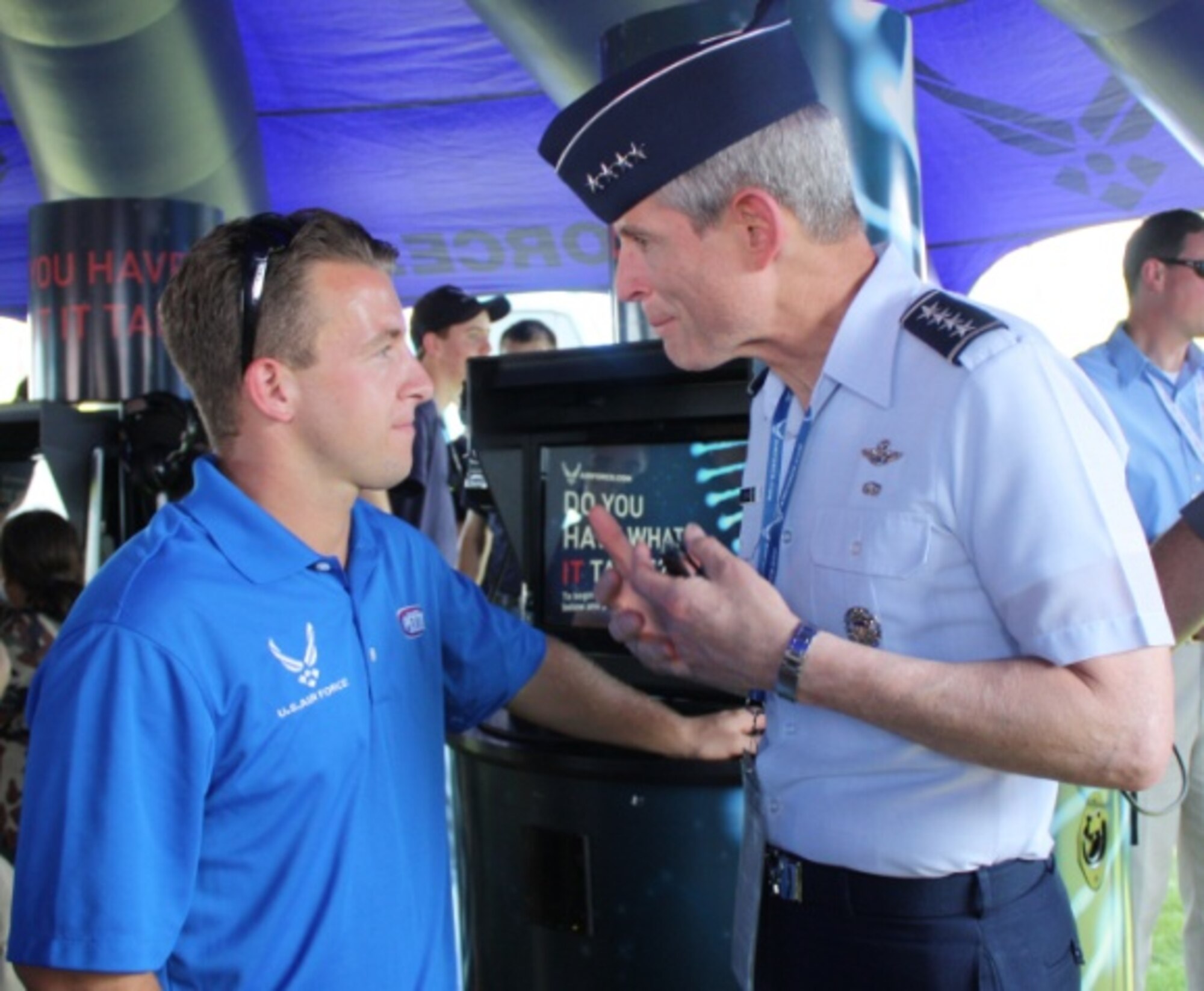 A.J. Allmendinger, NASCAR driver for the Air Force-sponsored #43 car, listens to Air Force Chief of Staff Gen. Norton Schwartz as he thanked him for taking time to support recruiting efforts and representing the Air Force. Allmendinger finished in the top ten July 2, 2011, at the Coke Zero 400 in Daytona Beach, Fla.   (U.S. Air Force photo/Capt. Maggie M. Silva)