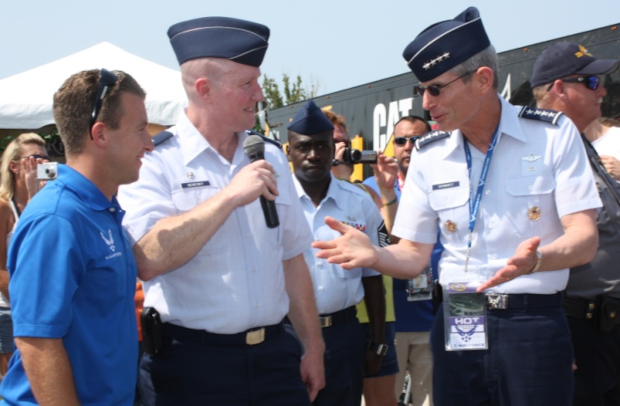 Air Force Chief of Staff Gen. Norton Schwartz and A.J. Allmendinger, NASCAR driver for the Air Force-sponsored #43 car (far left), are introduced to delayed enlisted members and their families by Lt. Col. John Deresky, 336th Recruiting Squadron commander. Schwartz spoke to the large crowd and 24 local delayed enlisted members at the Coke Zero 400 in Daytona Beach, Fla., July 2, 2011.  (U.S. Air Force photo/Capt. Maggie M. Silva)