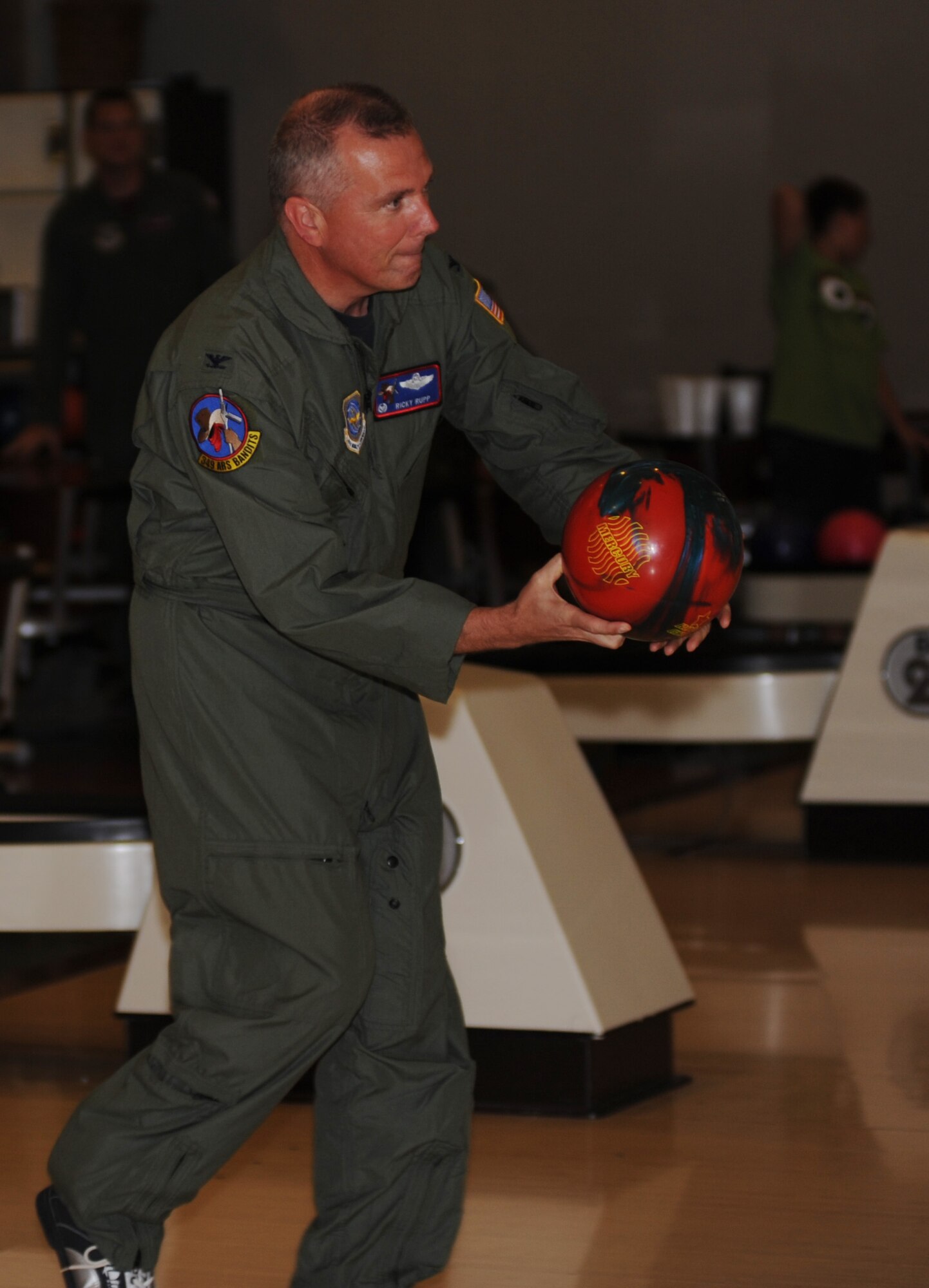 Col. Ricky Rupp, 22nd Air Refueling Wing commander, throws out the first ball, opening the 2011 Bowl for Kids’ Sake July 8, 2011, McConnell Air Force Base, Kan.  Team McConnell raised $10,000 for Kansas Big Brothers Big Sisters during the bowling event. (U.S. Air Force photo/ Airman 1st Class Laura L. Valentine)