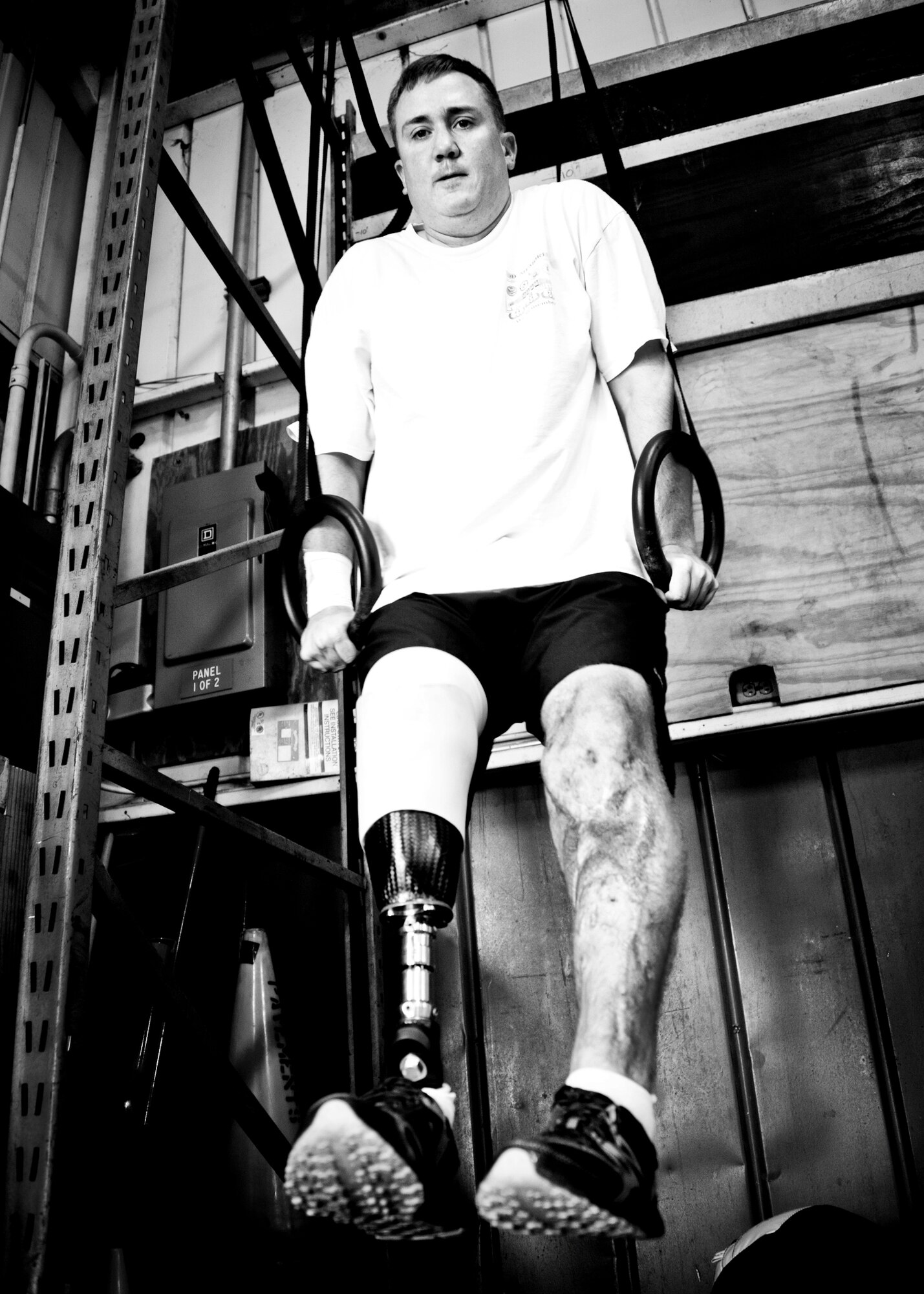 Staff Sgt. David Flowers holds himself up with the parallel rings during a workout June 28, 2011, at Eglin Air Force Base, Fla. The explosive ordnance technician was officially returned to duty in June after he lost his right leg and incurred major damage to his left leg in a land mine explosion in Afghanistan in 2009. In August, he is scheduled to begin training to be an EOD instructor at the Navy EOD School. Flowers is assigned to 366th Training Squadron, Det. 3. (U.S. Air Force photo/Samuel King Jr.)