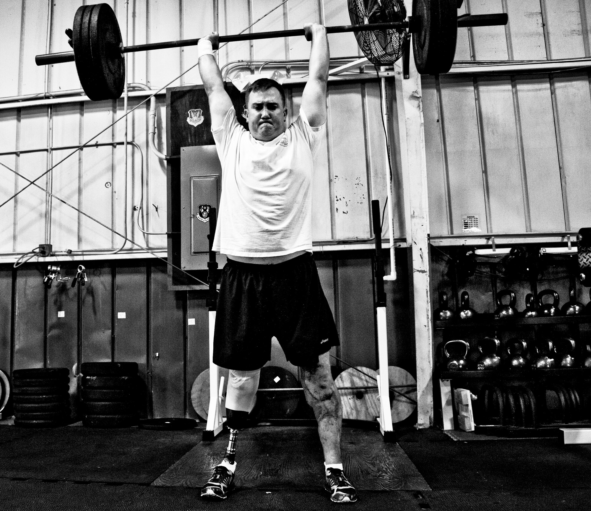 Staff Sgt. David Flowers adds weighted squats into his workout routine June 28, 2011, at Eglin Air Force Base, Fla. The explosive ordnance technician was officially returned to duty in June after he lost his right leg and incurred major damage to his left leg in a land mine explosion in Afghanistan in 2009. In August, he is scheduled to begin training to be an EOD instructor at the Navy EOD School. Flowers is assigned to 366th Training Squadron, Det. 3. (U.S. Air Force photo/Samuel King Jr.)