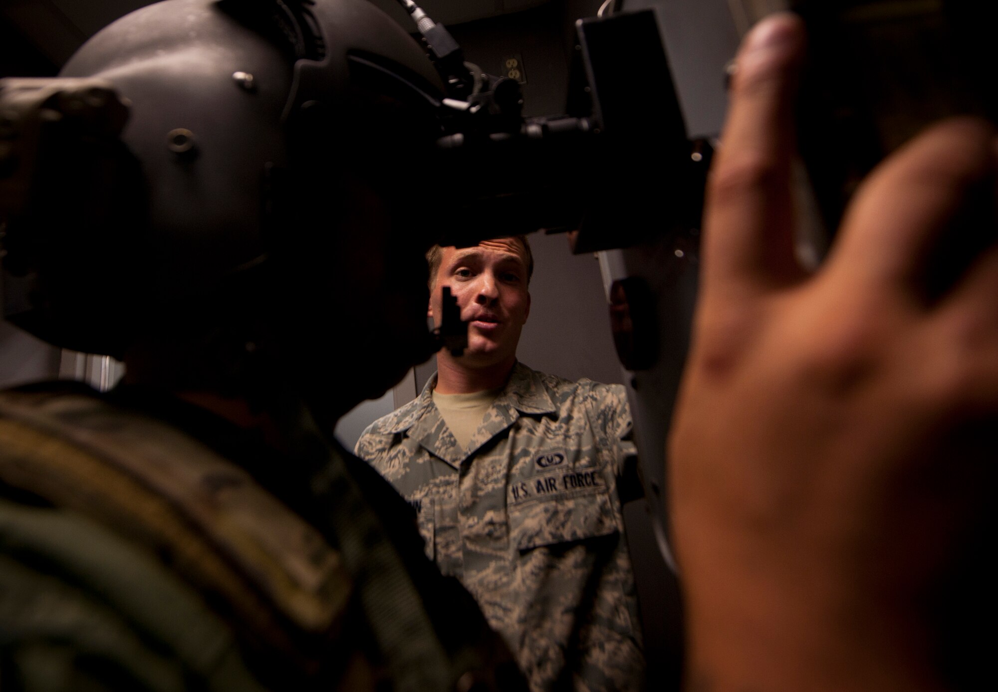 U.S. Air Force Airman 1st Class Jonathan Reischmann, 41st Rescue Squadron aircrew flight equipment apprentice, gives Staff Sgt. Antonio Delvercchio, 41st RQS flight engineer, a 20/20 night vision test, demonstrating the proper procedures before leaving on a night flight at Moody Air Force Base, Ga., July 11, 2011. The role of the aircrew flight member is extremely important they because they ensure all equipment is functioning properly and up to par since one mistake could jeopardize the mission or cost a life. (U.S. Air Force photo by Airman 1st Class Joshua Green/Released)
