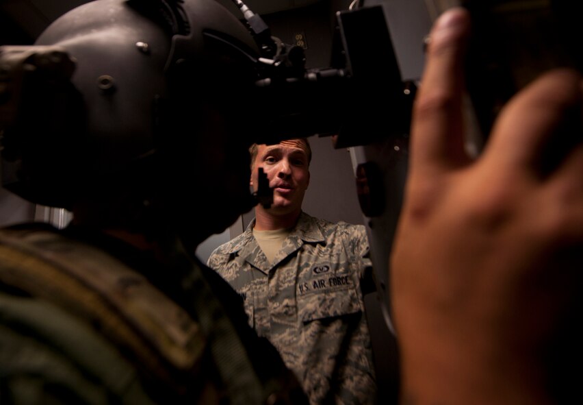 U.S. Air Force Airman 1st Class Jonathan Reischmann, 41st Rescue Squadron aircrew flight equipment apprentice, gives Staff Sgt. Antonio Delvercchio, 41st RQS flight engineer, a 20/20 night vision test, demonstrating the proper procedures before leaving on a night flight at Moody Air Force Base, Ga., July 11, 2011. The role of the aircrew flight member is extremely important they because they ensure all equipment is functioning properly and up to par since one mistake could jeopardize the mission or cost a life. (U.S. Air Force photo by Airman 1st Class Joshua Green/Released)
