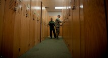 U.S. Air Force Staff Sgt. Antonio Delvercchio, 41st Rescue Squadron flight engineer and Airman 1st Class Jonathan Reischmann, 41st RQS aircrew flight equipment apprentice (right) pull gear out of a locker before demonstrating the proper equipment needed before taking off on a flight at Moody Air Force Base, Ga., July 11, 2011. HH-60G Pave Hawk pilots fly an estimated two-three times a week and the gear they wear has to be up to par in order to complete their mission. (U.S. Air Force photo by Airman 1st Class Joshua Green/Released)

