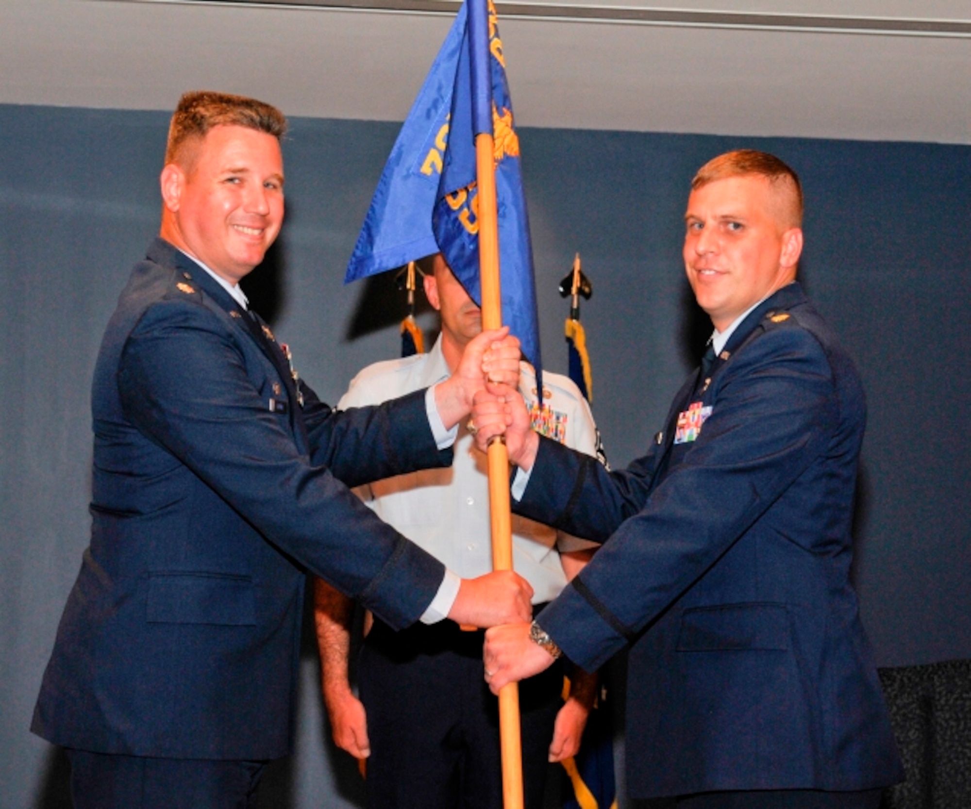 Lieutenant Col. William Grund, 325th Mission Support Group commander, passes command of the 325th Force Support Squadron to Maj. Kyle Head during a change of command ceremony July 11. Major Head replaces Maj. Letitia Marsh who departs Tyndall to serve at the Pentagon. Major Head arrives from Maxwell Air Force Base, Ala., where he attended Air Command and Staff College. (U.S. Air Force photo by Lisa Norman)