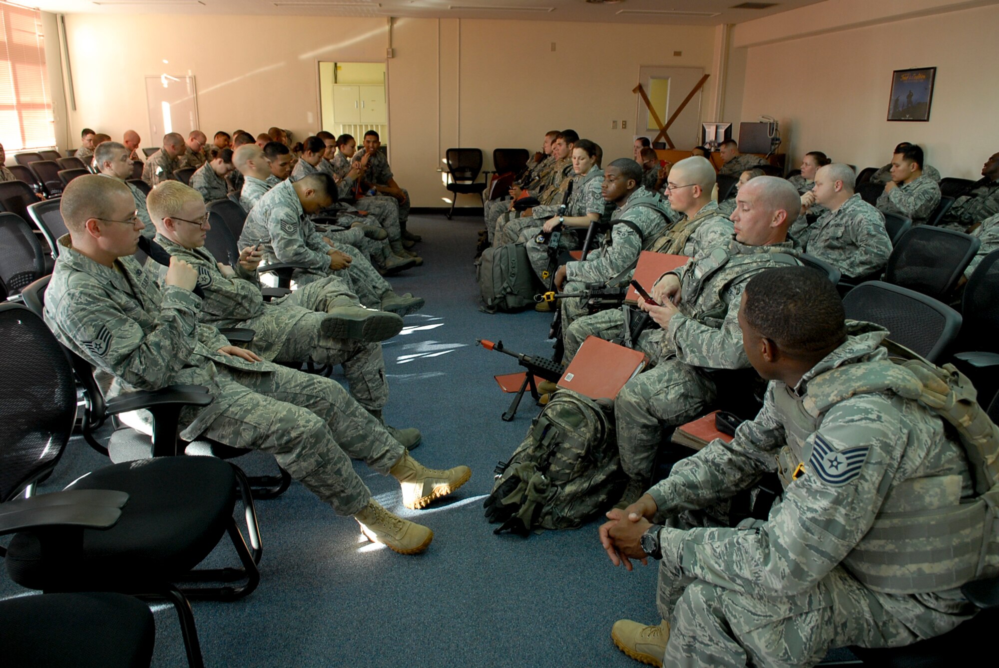 Airmen wait to have their mobility folders checked during the Local Operation Readiness Exercise July 11 at Kadena Air Base, Japan. LOREs are important to hone operational readiness skills, such as staying organized and preparing to deploy, so Airmen will be better prepared for what is expected of them during real-world contingencies. (U.S. Air Force photo/ Airman 1st Class Tara Williamson) 
