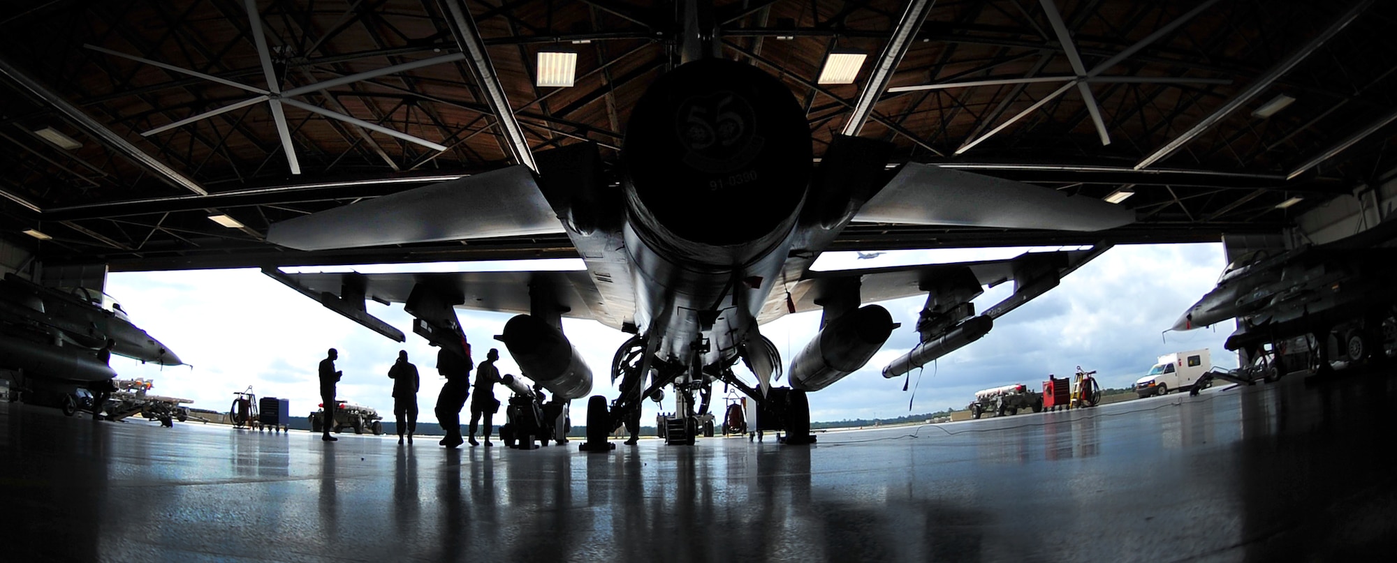 SHAW AIR FORCE BASE, S.C. -- Weapons load members with the 55th Aircraft Maintenance Unit, work together and move quickly during a weapons load competition here July 8, 2011. The 20th Fighter Wing weapons standardization held their quarterly weapons load crew of the quarter competition. The competition brings together weapons load crew members from all three fighter squadrons at Shaw to compete against each other to show who is the best. (U.S. Air Force photo by Senior Airman Kenny Holston)(Released) 

