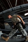 SHAW AIR FORCE BASE, S.C. -- A 77th Aircraft Maintenance Unit weapons load member, quickly makes his way around the wing of an F-16 to continue helping his team load munitions onto the aircraft during a weapons load competition here July 8, 2011. The 20th Fighter Wing weapons standardization held their quarterly weapons load crew of the quarter competition. The competition brings together weapons load crew members from all three fighter squadrons at Shaw to compete against each other to show who is the best. (U.S. Air Force photo by Senior Airman Kenny Holston)(Released)

