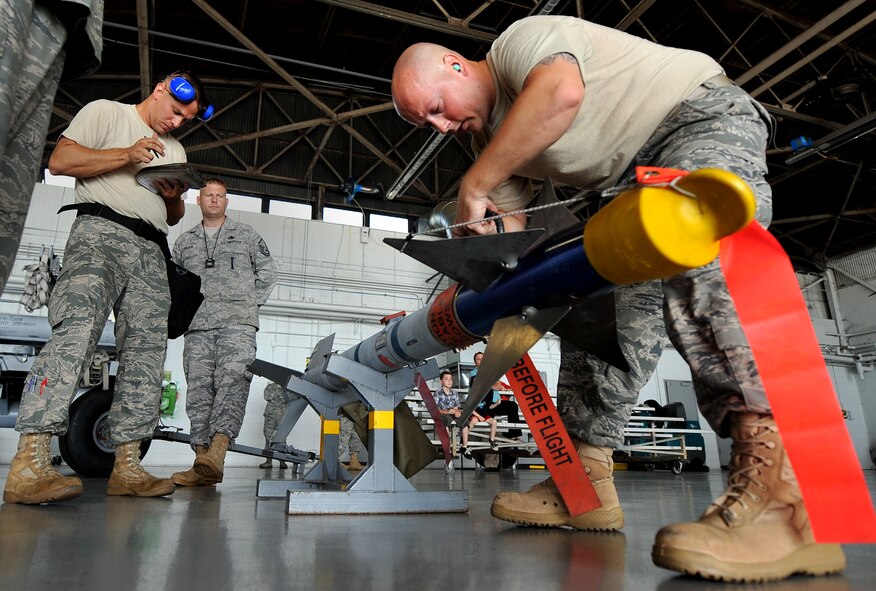 SHAW AIR FORCE BASE, S.C. -- A 77th Aircraft Maintenance Unit weapons load member, prepares an air-to-air sidewinder missile to be mounted on an F-16 during a weapons load competition here July 8, 2011. The 20th Fighter Wing weapons standardization held their quarterly weapons load crew of the quarter competition. The competition brings together weapons load crew members from all three fighter squadrons at Shaw to compete against each other to show who is the best. (U.S. Air Force photo by Senior Airman Kenny Holston)(Released)

