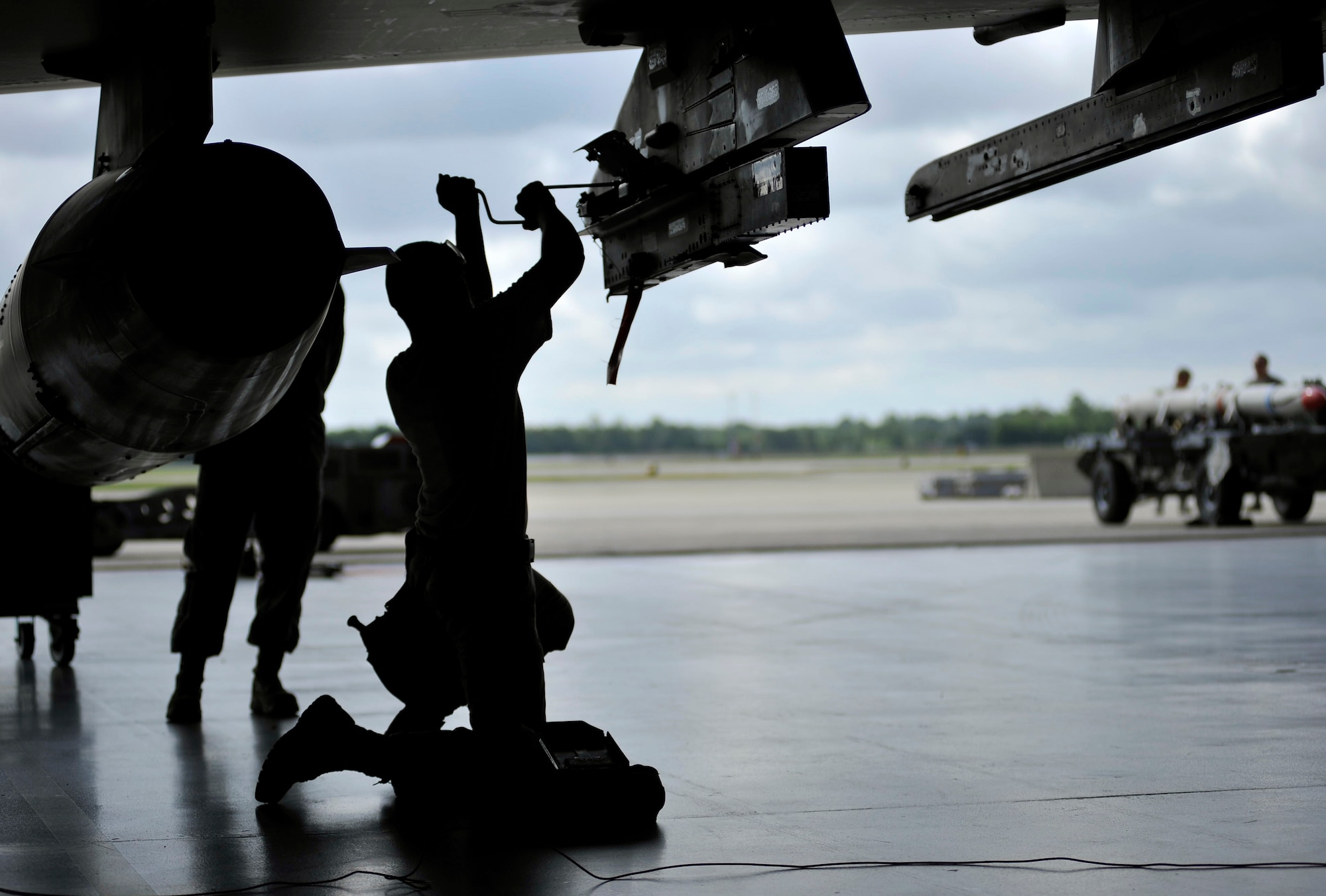 SHAW AIR FORCE BASE, S.C. -- Senior Airman Gerry Escalona, 55th Aircraft Maintenance Unit weapons load member, prepares an F-16 to have munitions loaded onto it during a weapons load competition here July 8, 2011. The 20th Fighter Wing weapons standardization held their quarterly weapons load crew of the quarter competition. The competition brings together weapons load crew members from all three fighter squadrons at Shaw to compete against each other to show who is the best. (U.S. Air Force photo by Senior Airman Kenny Holston)(Released) 

