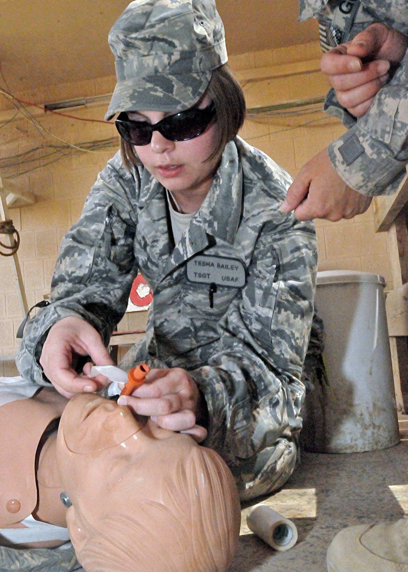 Tech. Sgt. Tesha Bailey inserts a nasopharyngeal airway into a medical mannequin to clear an obstructed airway during a tactical field care exercise, July 7, 2011, at Contingency Operating Site Marez, Iraq. Bailey, a financial management specialist assigned to the Air Force Financial Management Detachment there, attended the combat lifesaver refresher course conducted by Army combat medics assigned to Company C, 27th Brigade Support Battalion. (U.S. Army photo/Spc. Terence Ewings)