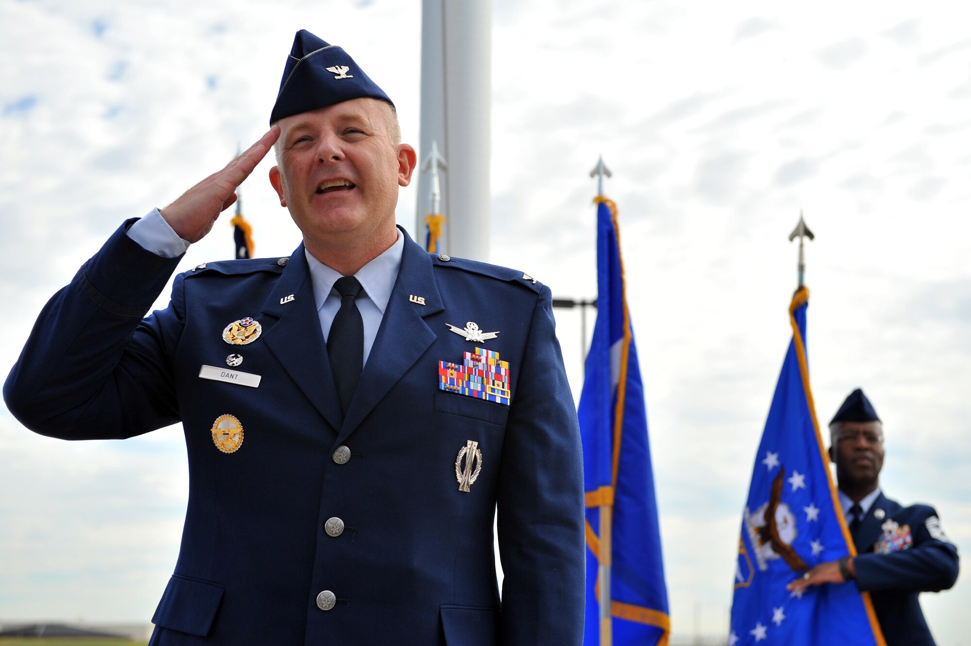 BUCKLEY AIR FORCE BASE, Colo. -- Colonel Daniel Dant, returns his first salute as the new commander of the 460th Space Wing during his Assumption of Command ceremony July 11, 2011. Dant comes to Buckley AFB after an assignment as Chief of Staff of the Air Force Fellow and Director of Space Policy, Office of the Secretary of Defense (Policy), Pentagon, Washington D.C. (U.S. Air Force photo by Staff Sgt. Kathrine McDowell) 