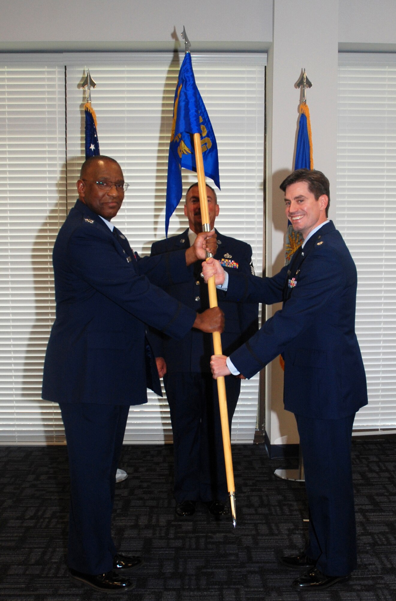 Lt. Col. David K. Dick, commander of the 94th Airlift Wing Force Support Squadron, receives the guidon from Col. Marshall S. Irvin, commander of the 94th AW Mission Support Group, to commemorate his assumption of command here July 9. (U.S. Air Force photo/Senior Airman Christina Bozeman)