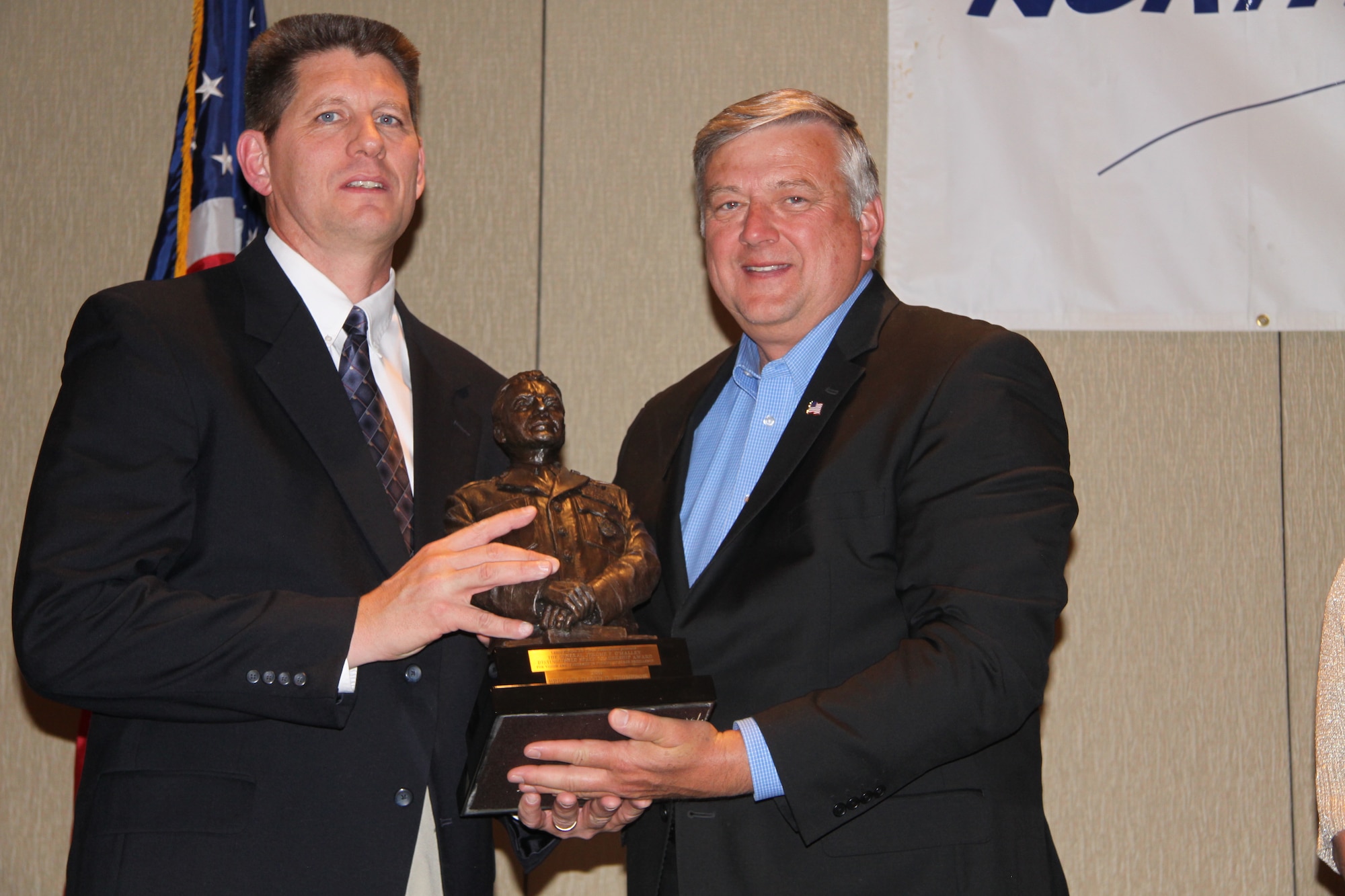 Brig. Gen. David D. Thompson, Director of Air, Space and Cyberspace Operations, Air Force Space Command, Peterson Air Force Base, Colo., receives the General Jerome F. O'Malley Distinguished Space Leadership Award from Mr. Kevin Estrem, President, Lance P. Sijan chapter of the Air Force Association during their symposium June 15, 2011. (Photo by Jane Rodgers)