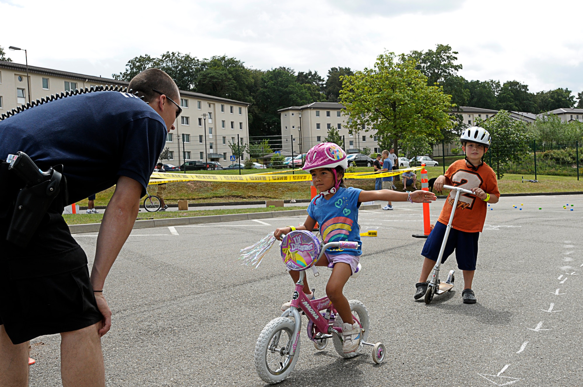 Jaidah Fuchs,5, daughter of U.S. Air Force Tech. Sgt. Gerald Fuchs, 603rd Air and Space Communications Squadron, signals left at a simulated four way stop during the bicycle rodeo, Vogelweh Military Complex, Germany, July 9, 2011. The rodeo was designed to teach children the skills they need in the order to be better bicyclist. Children received bike inspections, learned bicycle-handling skills and traffic rules. (U.S. Air Force photo by Airman 1st Class Desiree Esposito)