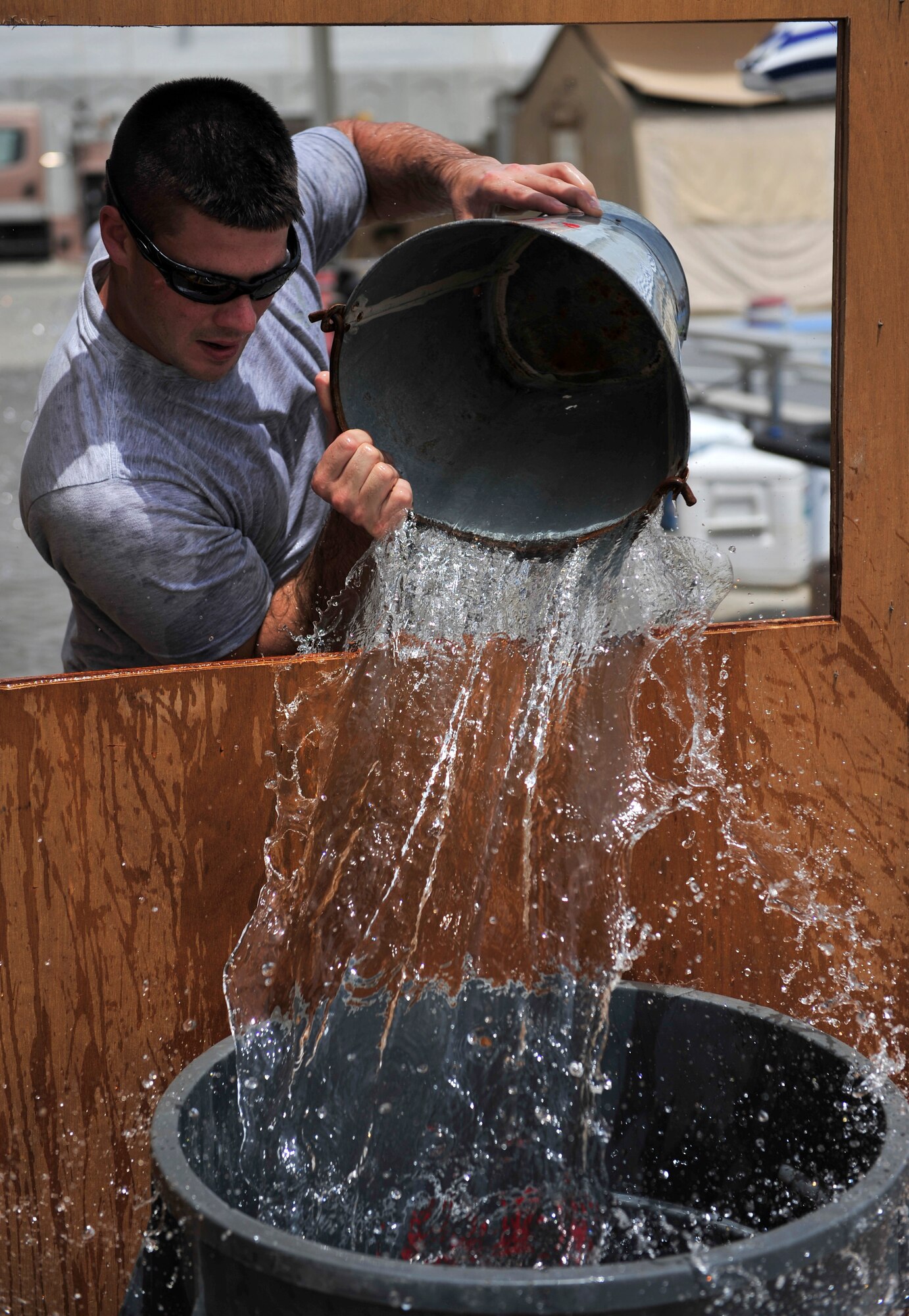 An Airman from the 380th Air Expeditionary Wing competes in a fire muster competition July 10, 2011. Six teams competed in the event, which has become a tradition organized by the fire department during each deployment rotation at the 380th AEW. (U.S. Air Force photo by Staff Sgt. Patrick Mitchell)