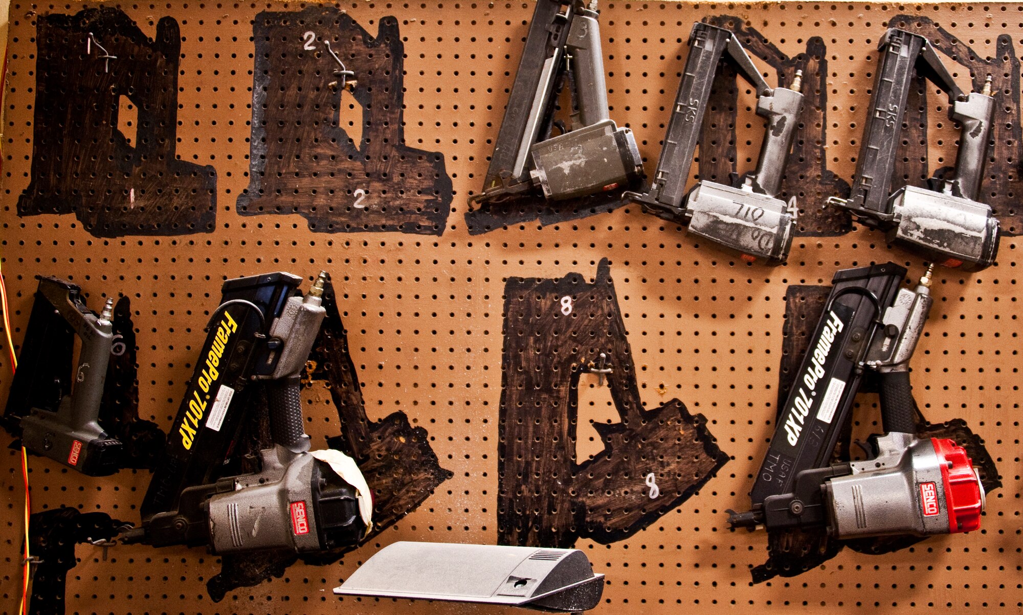 Power tools sit in their proper place ready for use in the 96th Logistics Readiness Squadron’s cargo movement wood shop.  Wooden boxes are assembled to secure and ship specific items from Eglin Air Force Base, Fla.  Measurements of the items to be shipped are taken and used to produce specifications for the type of box needed to ship it.  Personnel in the wood shop can build a box to meet those specifications needed.  (U.S. Air Force photo/Samuel King Jr.)   