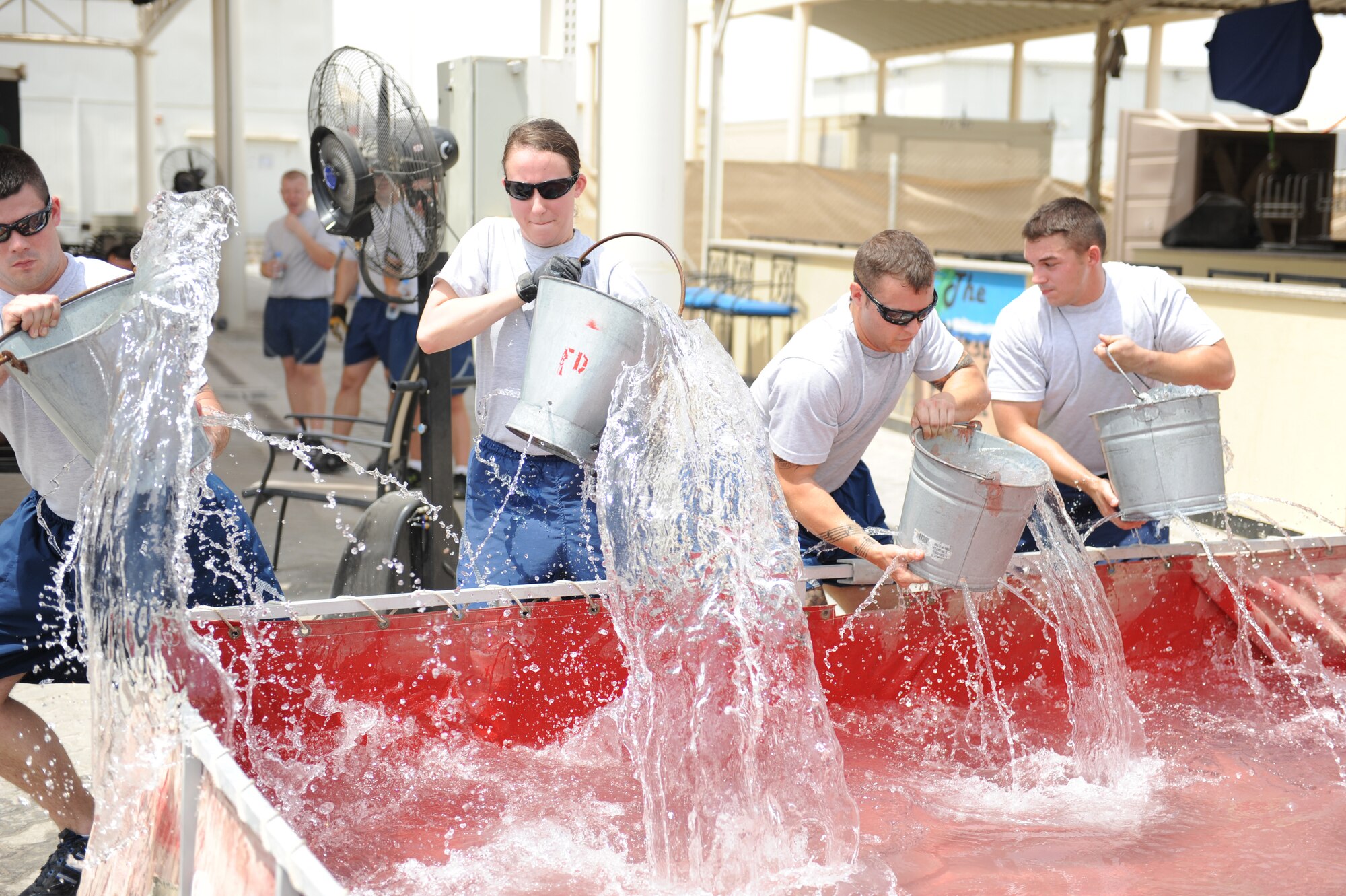 Airmen from the 380th Air Expeditionary Wing compete in a fire muster competition July 10, 2011. Six teams competed in the event, which was organized by the fire department and has become a tradition during each deployment rotation at the 380th Air Expeditionary Wing. The team from the Expeditionary Logistics Readiness Squadron won the event. (U.S. Air Force photo by Staff Sgt. Patrick Mitchell)