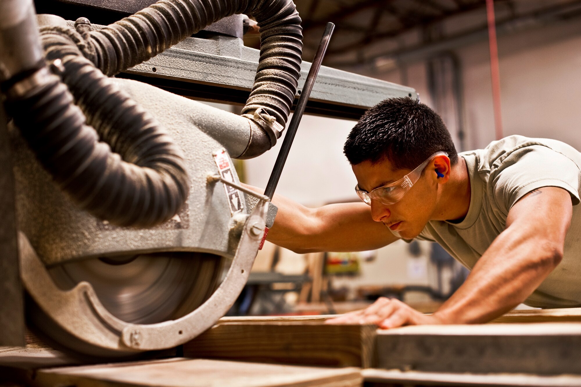 Airman 1st Class Jeremy Gonzales of 96th Logistics Readiness Squadron cargo movement, brings the saw through the wood before measuring and nailing it into place to create shipping box.  The box will be used to secure and ship a large item from the base.  Measurements of the items to be shipped are taken and used to produce specifications for the type of box needed to ship it.  Personnel in the wood shop can build a box to meet those specifications needed to secure and ship the item.  (U.S. Air Force photo/Samuel King Jr.)   