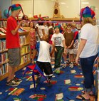 LAUGHLIN AIR FORCE BASE, Texas--Vincent Terrell, son of Maj. Vincent Terrell, 47th Communications Squadron commander, and Machelle Terrell, 47th Flying Training Wing sexual assault response coordinator, plays a game of limbo during Laughlin’s Book Mark Library’s ‘A Midsummer Knight’s Read’ program here July 5. The program gives kids of all ages a chance to read books, play games and win prizes. (U.S. Air Force photo by Gaby Jimenez)