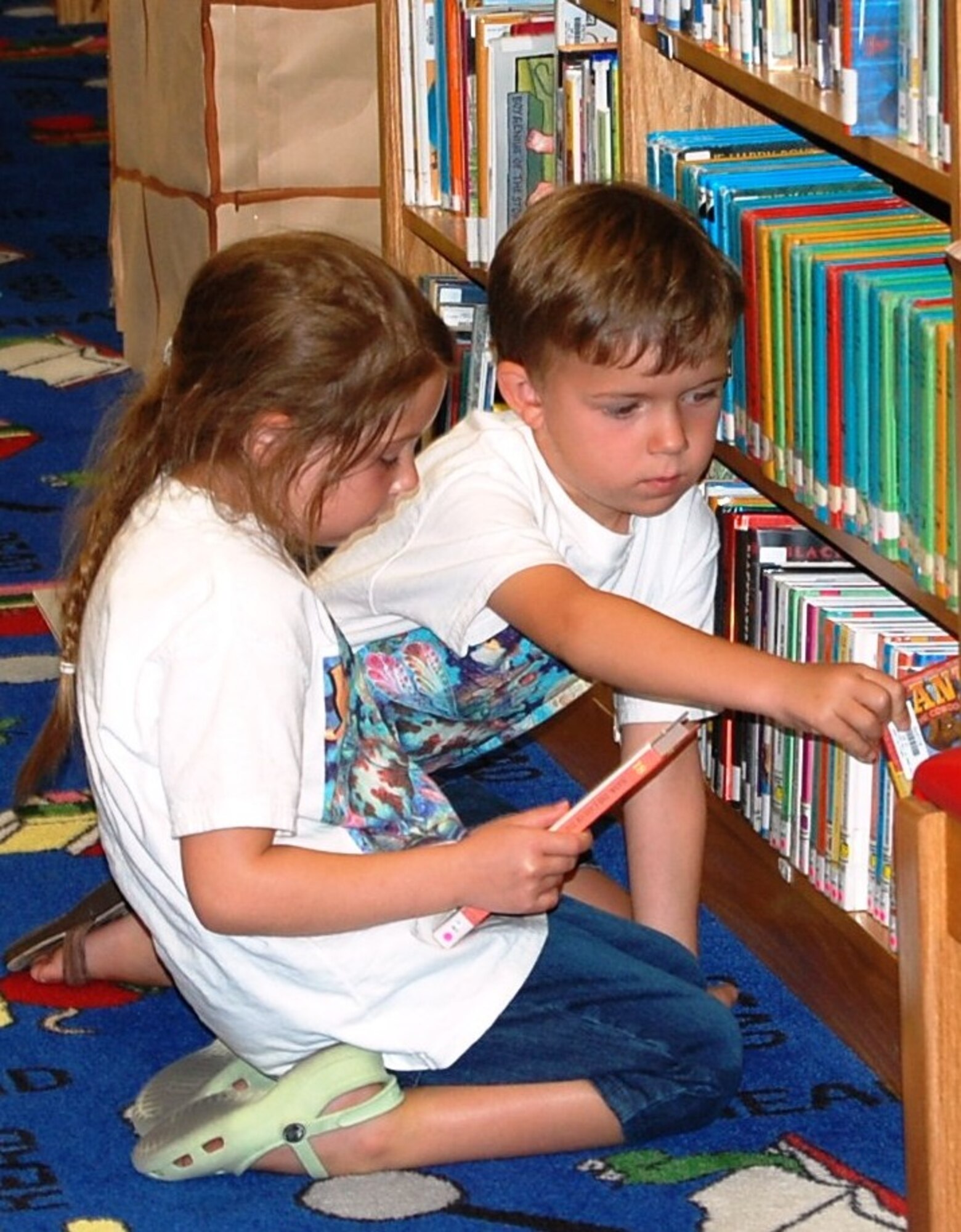 LAUGHLIN AIR FORCE BASE, Texas—Two Laughlin youth select books they want to read during Laughlin’s ‘A Midsummer Knight’s Read’ program here July 5. The program is for students in pre-school through high school and encourages literacy throughout their summer vacation. (U.S. Air Force photo by Gaby Jimenez)