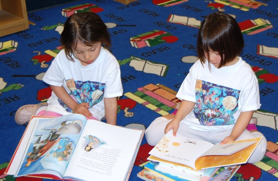 LAUGHLIN AIR FORCE BASE, Texas-- Two Laughlin children read their selected books during Laughlin’s Book Mark Library’s ‘A Midsummer Knight’s Read’ program July 5. The program challenges students to read 12 age-appropriate books or read for more than 12 hours. (U.S. Air Force photo by Gaby Jimenez)