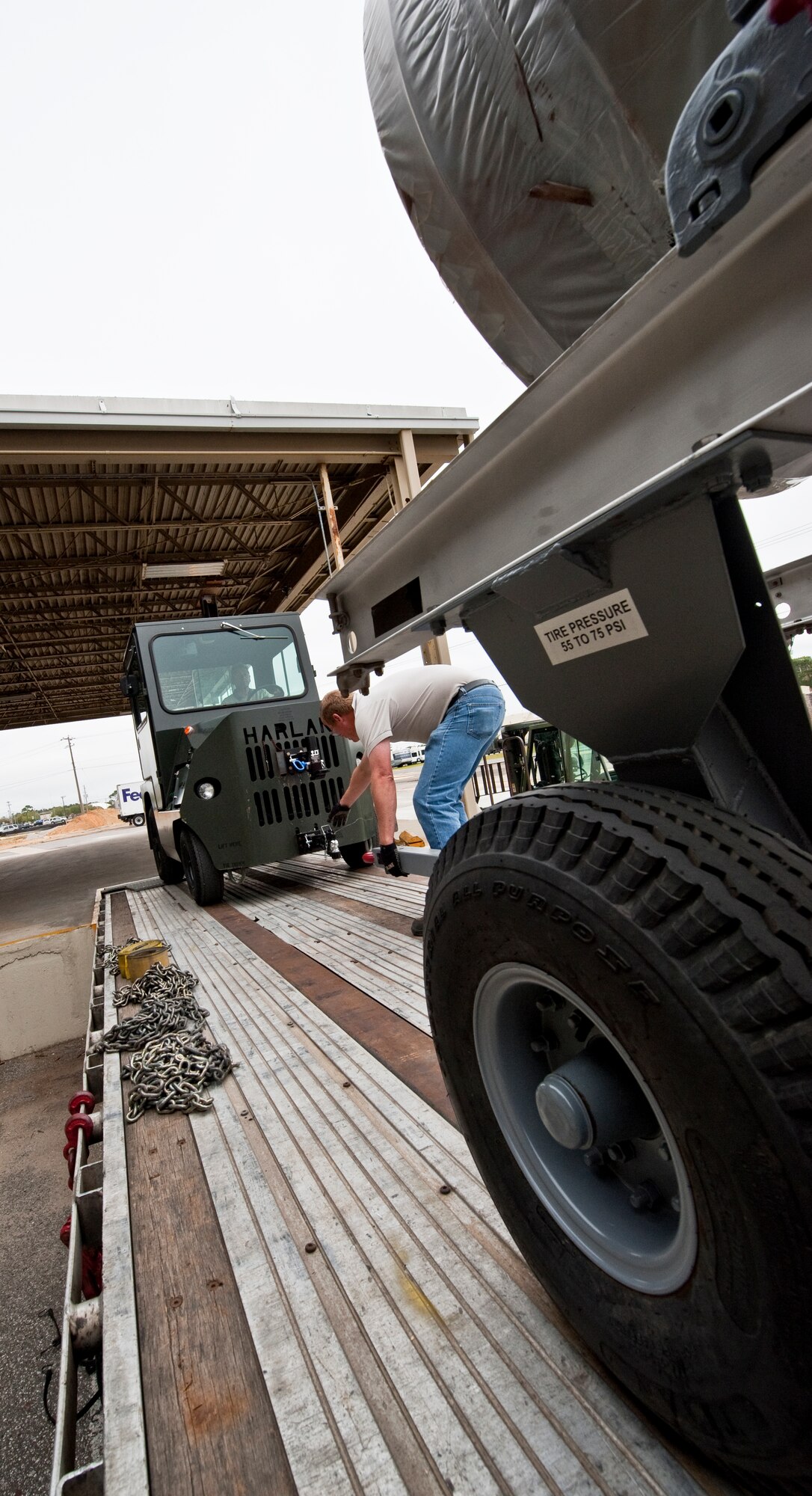 A 96th Logistics Readiness Squadron cargo movement employee connects the wagon to the tractor before removing the A-10 engines from the trailer at Eglin Air Force Base, Fla.  The 45 personnel of cargo movement unload and ship out an almost 15,000 pieces through commercial carriers each year.  Their in-house capabilities allow them to create virtually any type of shipping material need to store, secure and ship an item from Eglin.  (U.S. Air Force photo/Samuel King Jr.)   