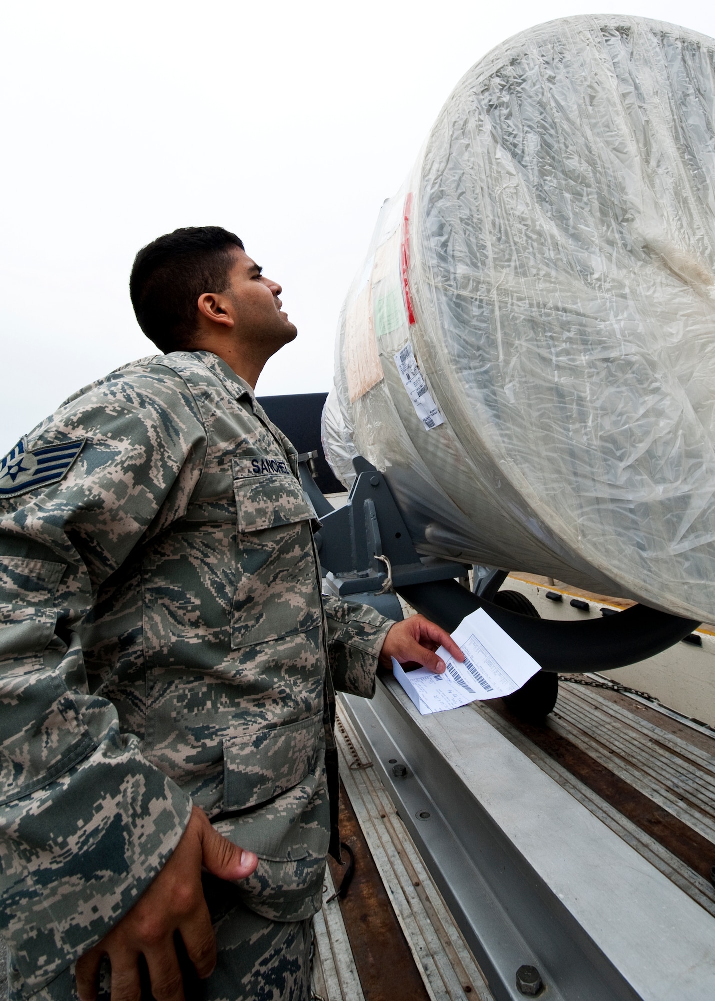 Staff Sgt. Nick Sanchez of 96th Logistics Readiness Squadron cargo movement, pulls the paperwork for an A-10 engine to ensure accuracy and responsibility prior to accepting delivery onto Eglin Air Force Base, Fla.  The 45 personnel of cargo movement unload and ship out an almost 15,000 pieces through commercial carriers each year.  Their in-house capabilities allow them to create virtually any type of shipping material need to store, secure and ship an item from Eglin.  (U.S. Air Force photo/Samuel King Jr.)