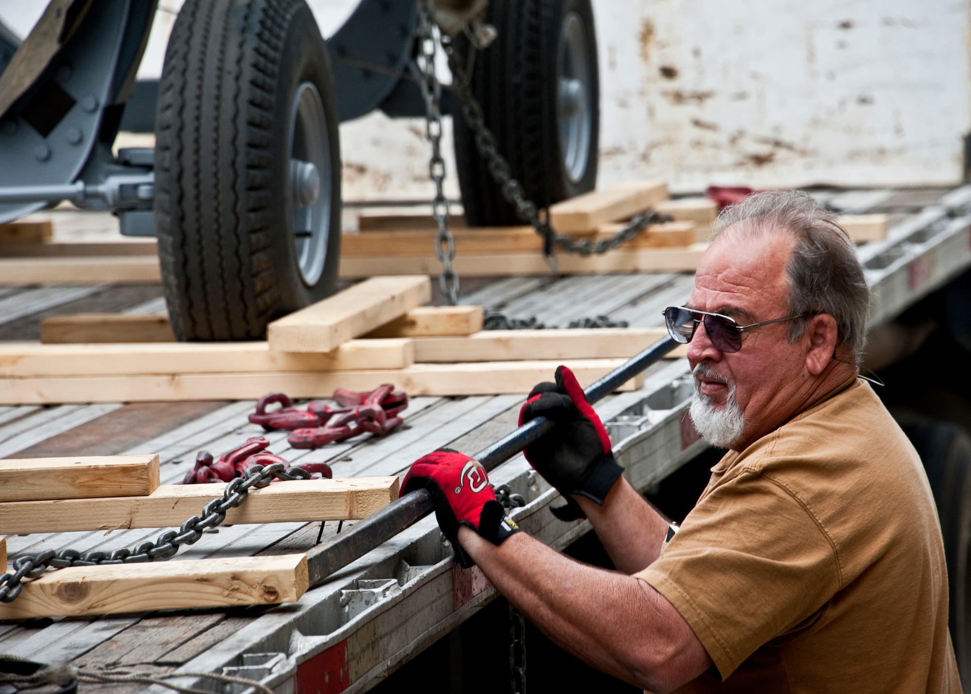 Don Snyder of 96th Logistics Readiness Squadron cargo movement, removes the wooden braces from a trailer holding A-10 engines at Eglin Air Force Base, Fla.  The 45 personnel of cargo movement unload and ship out an almost 15,000 pieces through commercial carriers each year.  Their in-house capabilities allow them to create virtually any type of shipping material need to store, secure and ship an item from Eglin.  (U.S. Air Force photo/Samuel King Jr.)
