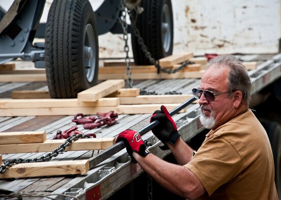 Don Snyder of 96th Logistics Readiness Squadron cargo movement, removes the wooden braces from a trailer holding A-10 engines at Eglin Air Force Base, Fla.  The 45 personnel of cargo movement unload and ship out an almost 15,000 pieces through commercial carriers each year.  Their in-house capabilities allow them to create virtually any type of shipping material need to store, secure and ship an item from Eglin.  (U.S. Air Force photo/Samuel King Jr.)
