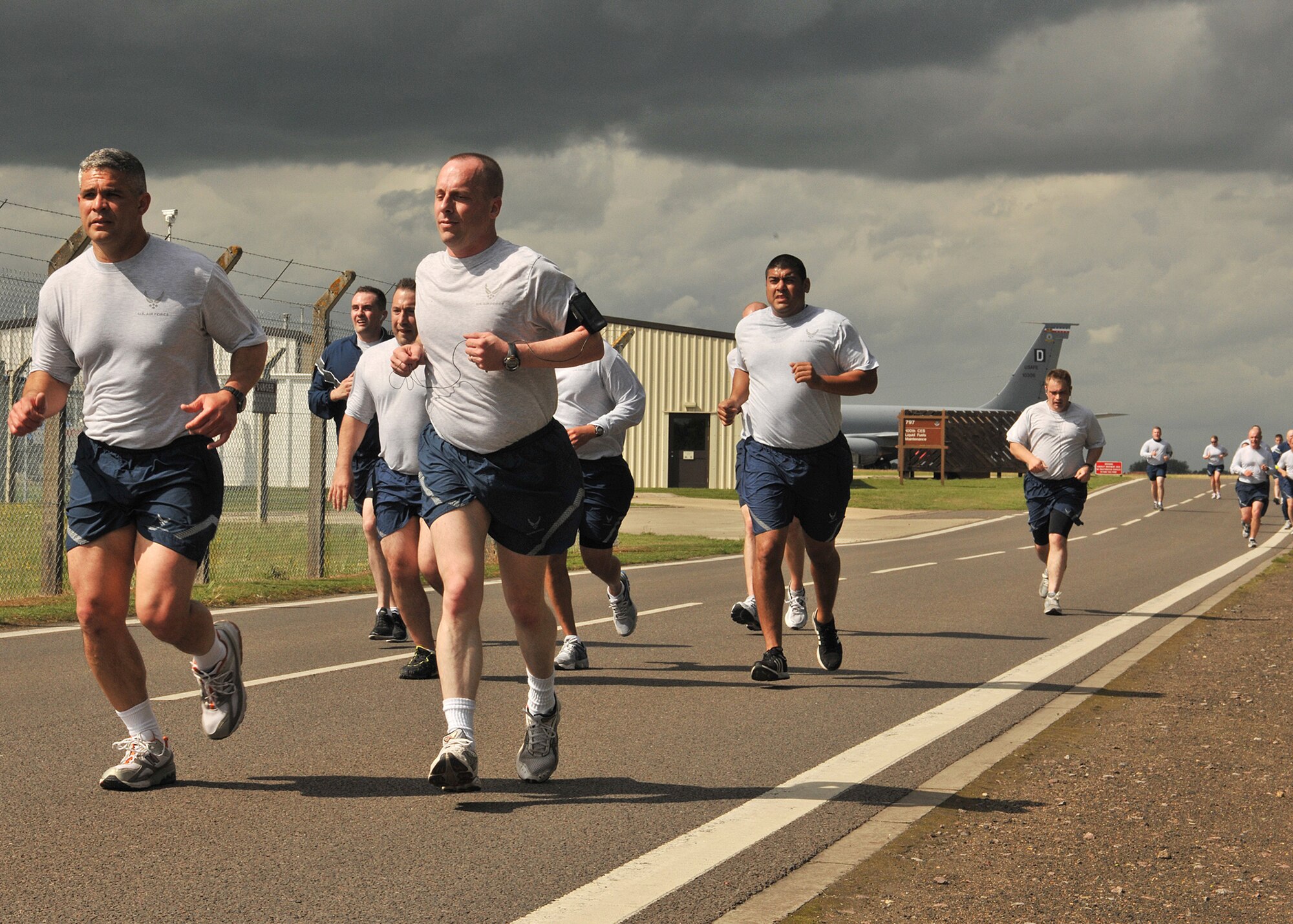 RAF MILDENHALL, England -- Airmen from Team Mildenhall compete in the monthly 5K fun run along perimeter road July 8, 2011.  The run gives Airmen an opportunity to enhance their physical fitness through healthy competition with their peers. (U.S. Air Force photo/Staff Sgt. Tabitha M. Lee)  