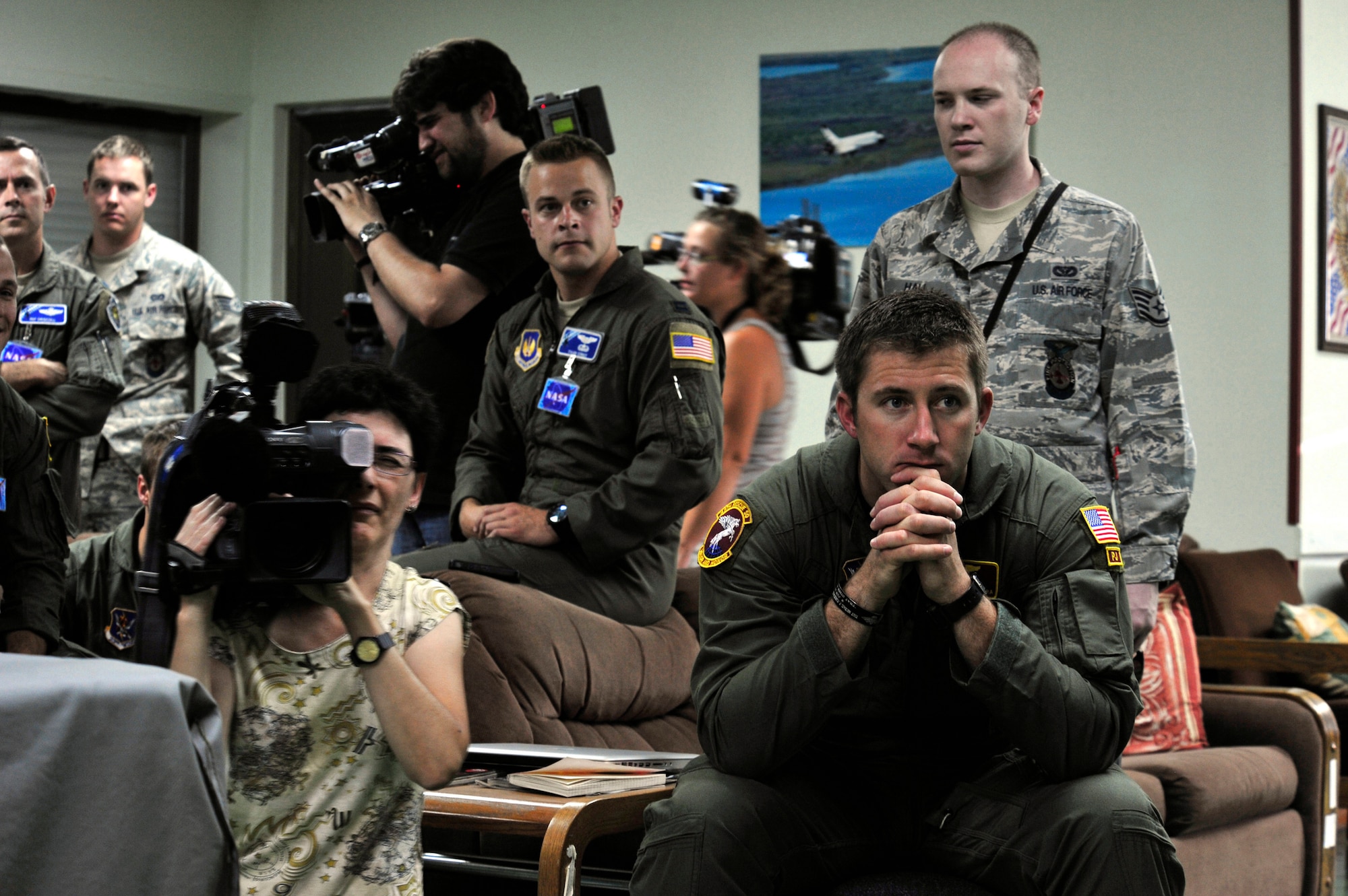 U.S. Air Force Airmen and members of the Spanish media stand-by and wait for the space shuttle launch, July 8, 2011, Zaragoza Air Base, Spain.  As space shuttle Atlantis makes it's final launch into orbit, personnel from DoD, NASA, and the Spanish Air Force work together to prepare for a possible emergency landing at the Transoceanic Abort Landing Site, Zaragoza Air Base, Spain. This particular TAL is one of three primary landing sites within U.S. Air Forces Europe, and this is the 135th mission the U.S. military has supported.  (U.S. Air Force photo by Tech. Sgt. Chenzira Mallory)