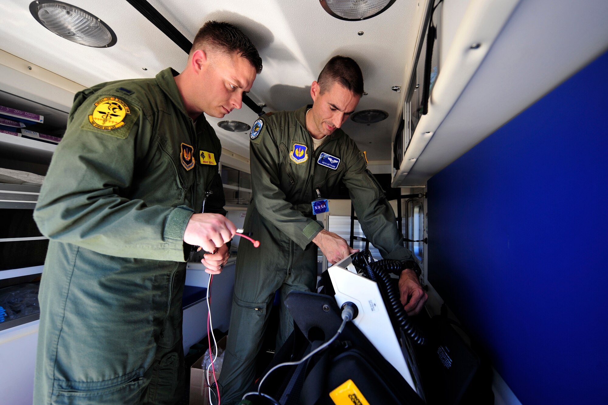 (l-r) U.S. Air Force 1st Lt. Bradley Tiefel, 86th Medical Squadron critical care nurse and Maj. Kevin Hettinger, 435th Contingency Response Group physician, perform ops checks on their medical equipment prior to the space shuttle launch, July 8, 2011, Zaragoza Air Base, Spain.  As space shuttle Atlantis makes it's final launch into orbit, personnel from DoD, NASA, and the Spanish Air Force work together to prepare for a possible emergency landing at the Transoceanic Abort Landing Site, Zaragoza Air Base, Spain. This particular TAL is one of three primary landing sites within U.S. Air Forces Europe, and this is the 135th mission the U.S. military has supported. (U.S. Air Force photo by Tech. Sgt. Chenzira Mallory)