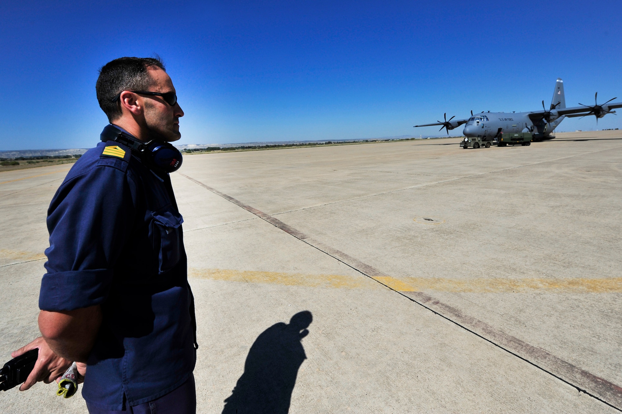 Spanish Air Force, Master Sgt. Javier Rodriguez Celada, 31st Wing C-130 mechanic, stands-by while U.S. Airmen perform start-up checks on a C-130J prior to the space shuttle launch, July 8, 2011, Zaragoza Air Base, Spain.  As space shuttle Atlantis makes it's final launch into orbit, personnel from DoD, NASA, and the Spanish Air Force work together to prepare for a possible emergency landing at the Transoceanic Abort Landing Site, Zaragoza Air Base, Spain. This particular TAL is one of three primary landing sites within U.S. Air Forces Europe, and this is the 135th mission the U.S. military has supported.(U.S. Air Force photo by Tech. Sgt. Chenzira Mallory)