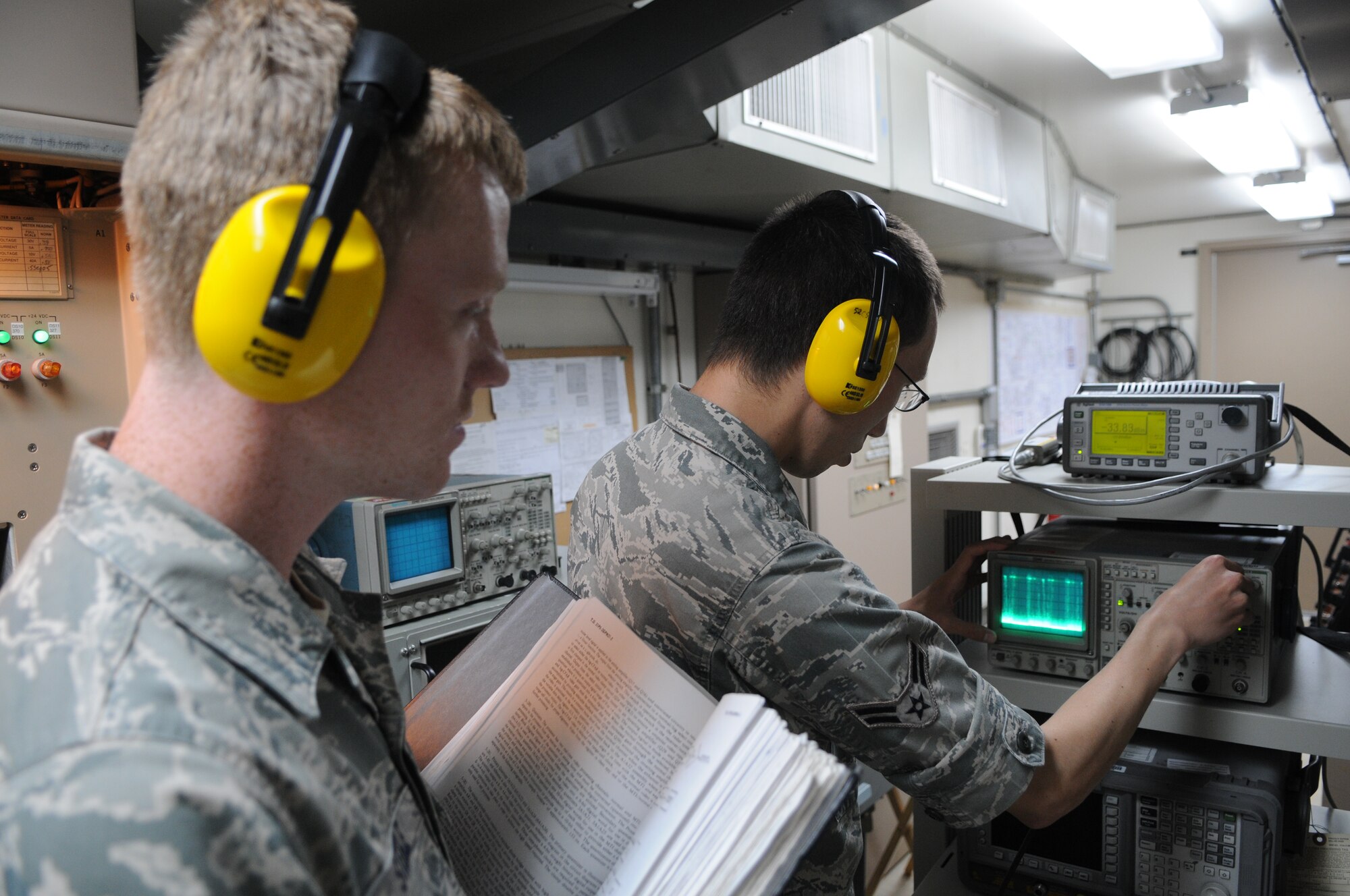 SPANGDAHLEM AIR BASE, Germany – Airman 1st Class Jacob Steele, 52nd Communications Squadron ground radar systems apprentice, watches as Airman 1st Class Mark Detwiler, 52nd CS ground radar systems apprentice, checks processor video levels to ensure they are sufficient enough to send to the base’s air traffic control tower here July 5. The 52nd CS’s ground radar systems Airmen are on the job all hours of the day to maintain and control the two radar systems that send information to the air-traffic control tower. (U.S. Air Force photo/Senior Airman Nick Wilson)