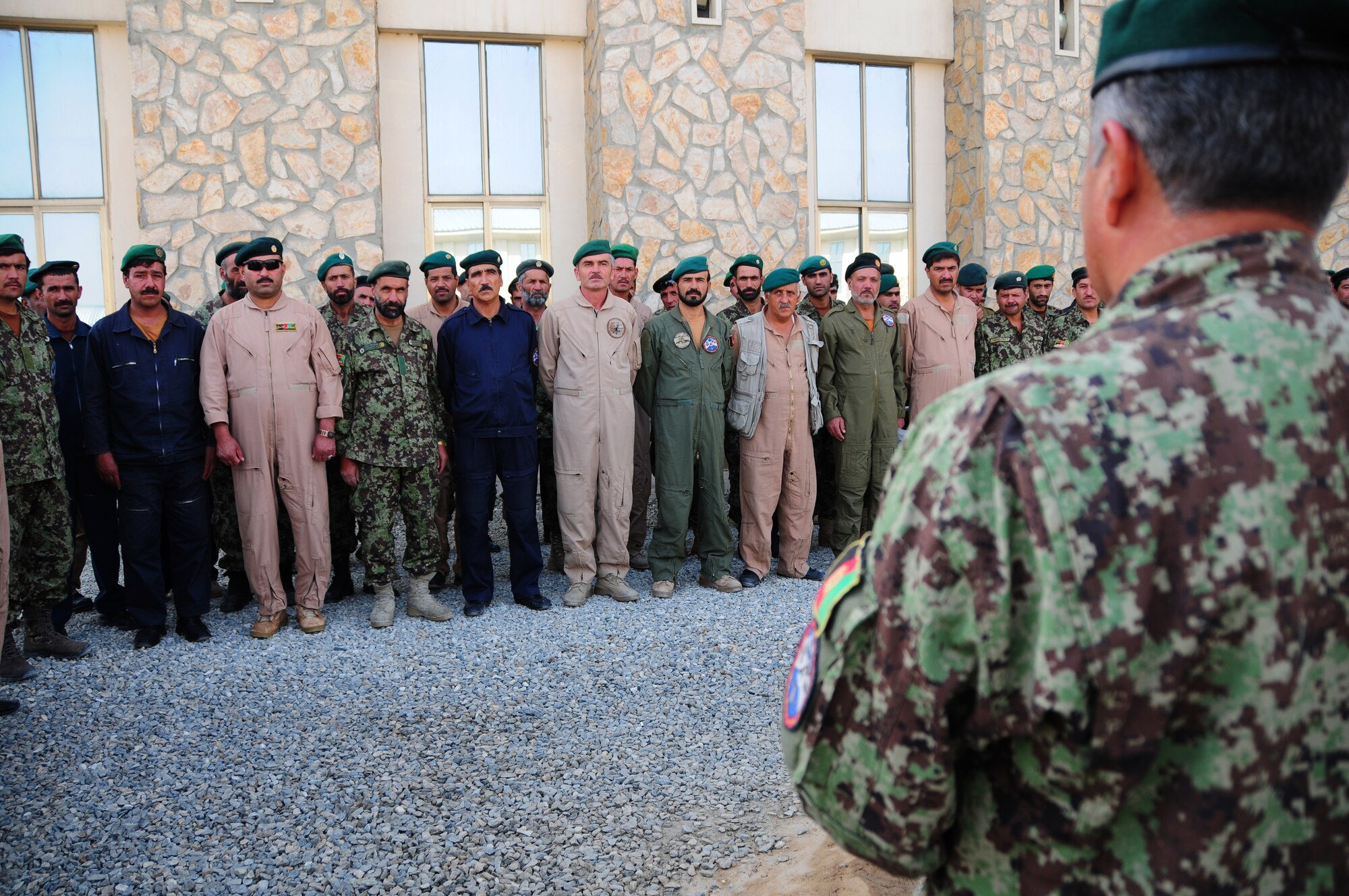 An Afghan Air Force maintenance commander, speakes to graduates from the first-ever rotary-wing maintenance train-the-trainer course at Kabul International Airport, Kabul, Afghanistan July 11, 2011.  The graduating group is now qualified to instruct three different training levels outlined in their training records.  Master Sgt. Walt Shaffer, deployed from Kirtland AFB, N.M., faciliated the training.  (U.S. Air Force photo by Senior Airman Amber Williams)