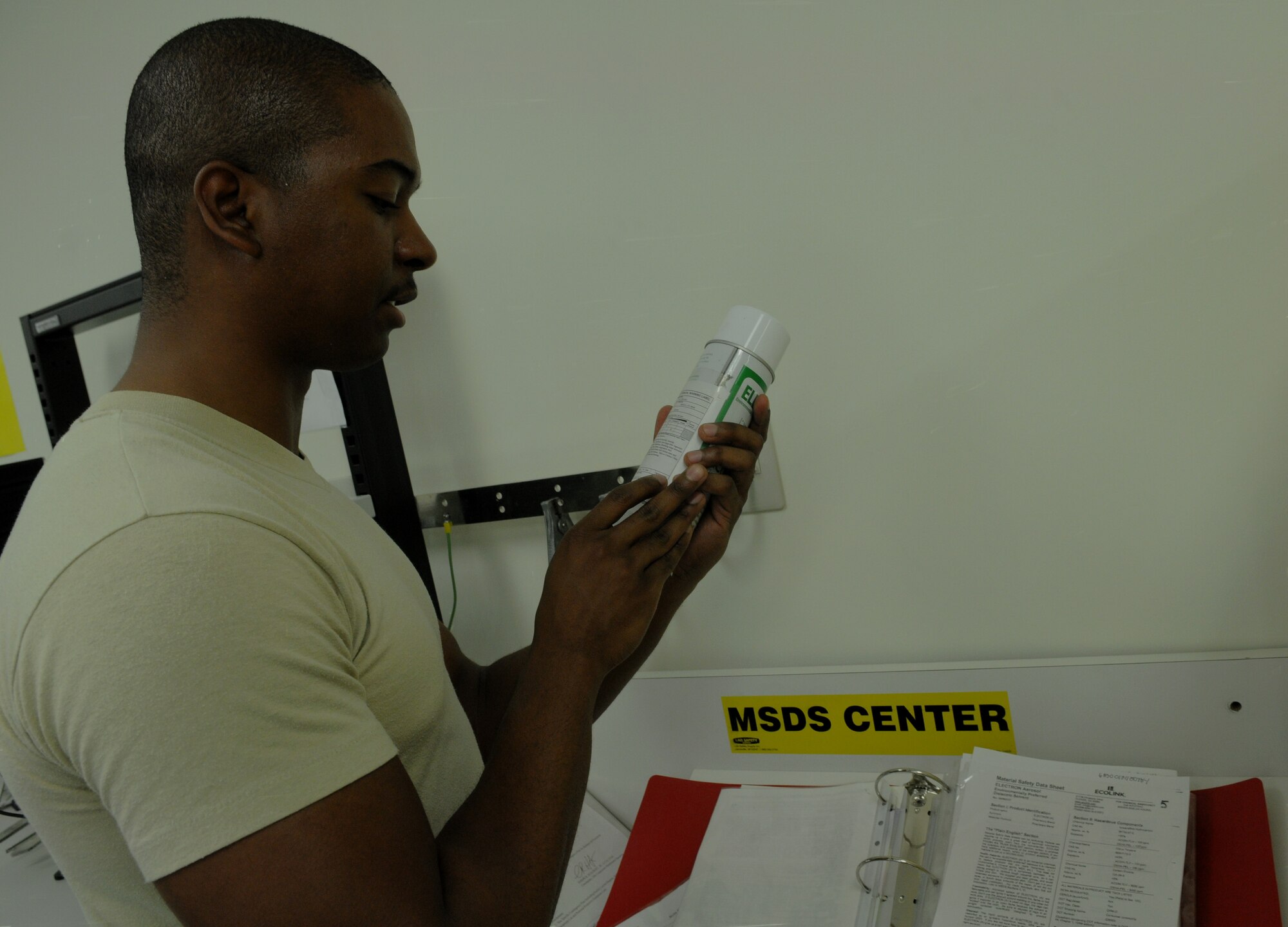 Airman 1st Class Alexander Tatum, 18th Component Maintenance Squadron precision measurement equipment laboratory technician, checks first-aid protocol on removing a hazardous material that was spilled in the eyes of a simulated victim during a Local Operational Readiness Exercise July 11 at Kadena Air Base, Japan. Beverly High 11-05, the July LORE, is one way the Airmen train for real-world scenarios they might be presented with. (U.S. Air Force photo/Airman 1st Class Jarvie Z. Wallace)