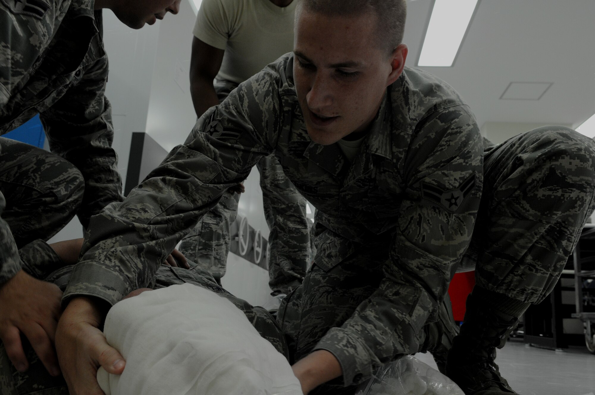 Airman 1st Class Michael Adkins, 18th Component Maintenance Squadron precision measurement equipment laboratory technician places a bandage around the eyes of a simulated victim after the victim accidently spill chemicals in his eyes an exercise July 11 at Kadena Air Base, Japan. Kadena's personnel are participating in exercise Beverly High 11-05 to stay prepared for real-world contingencies.  (U.S. Air Force photo/Airman 1st Class Jarvie Z. Wallace)

